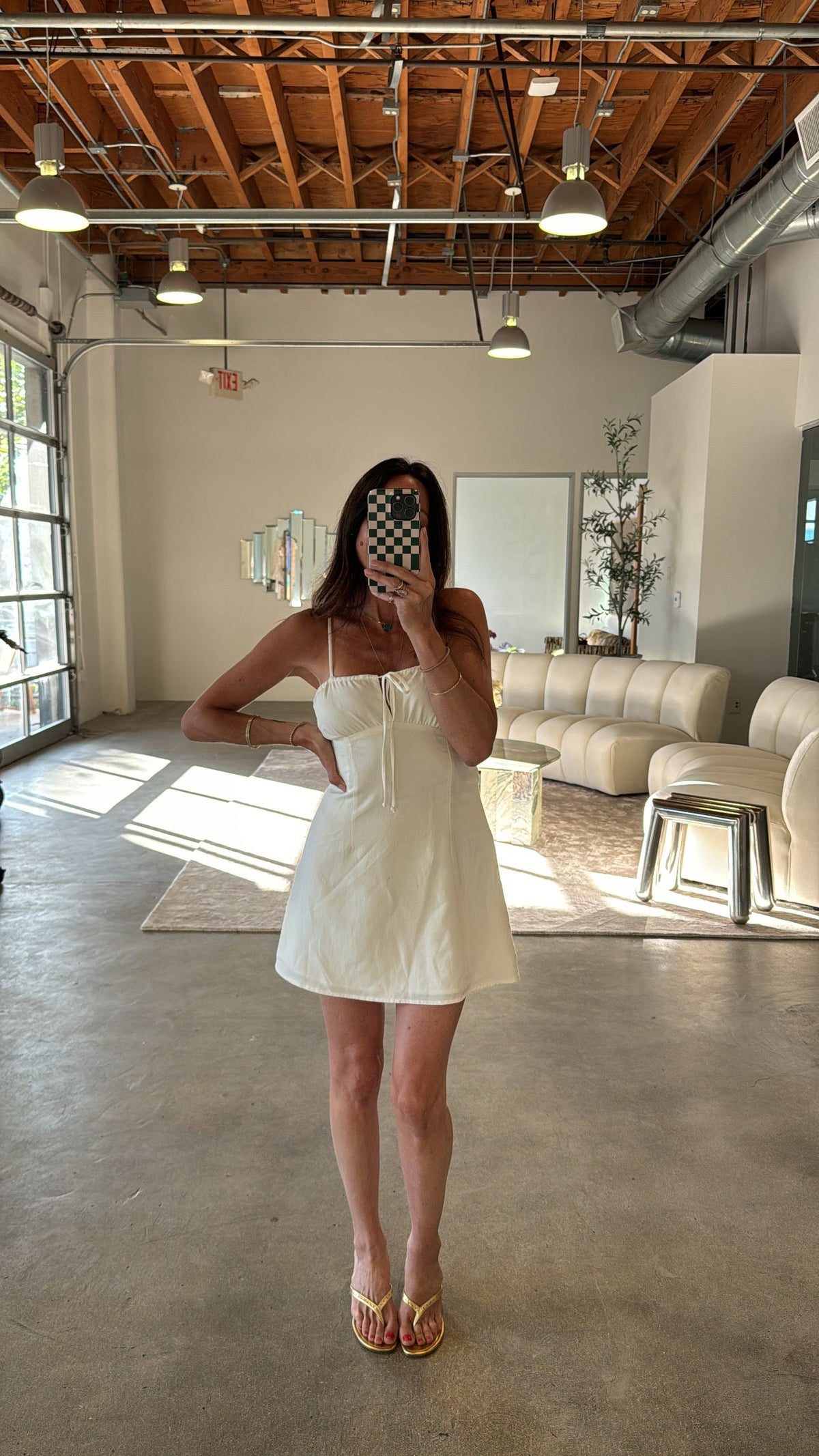 This is an image of Lauren Mini Dress in White Linen - RESA featuring a model wearing the dress