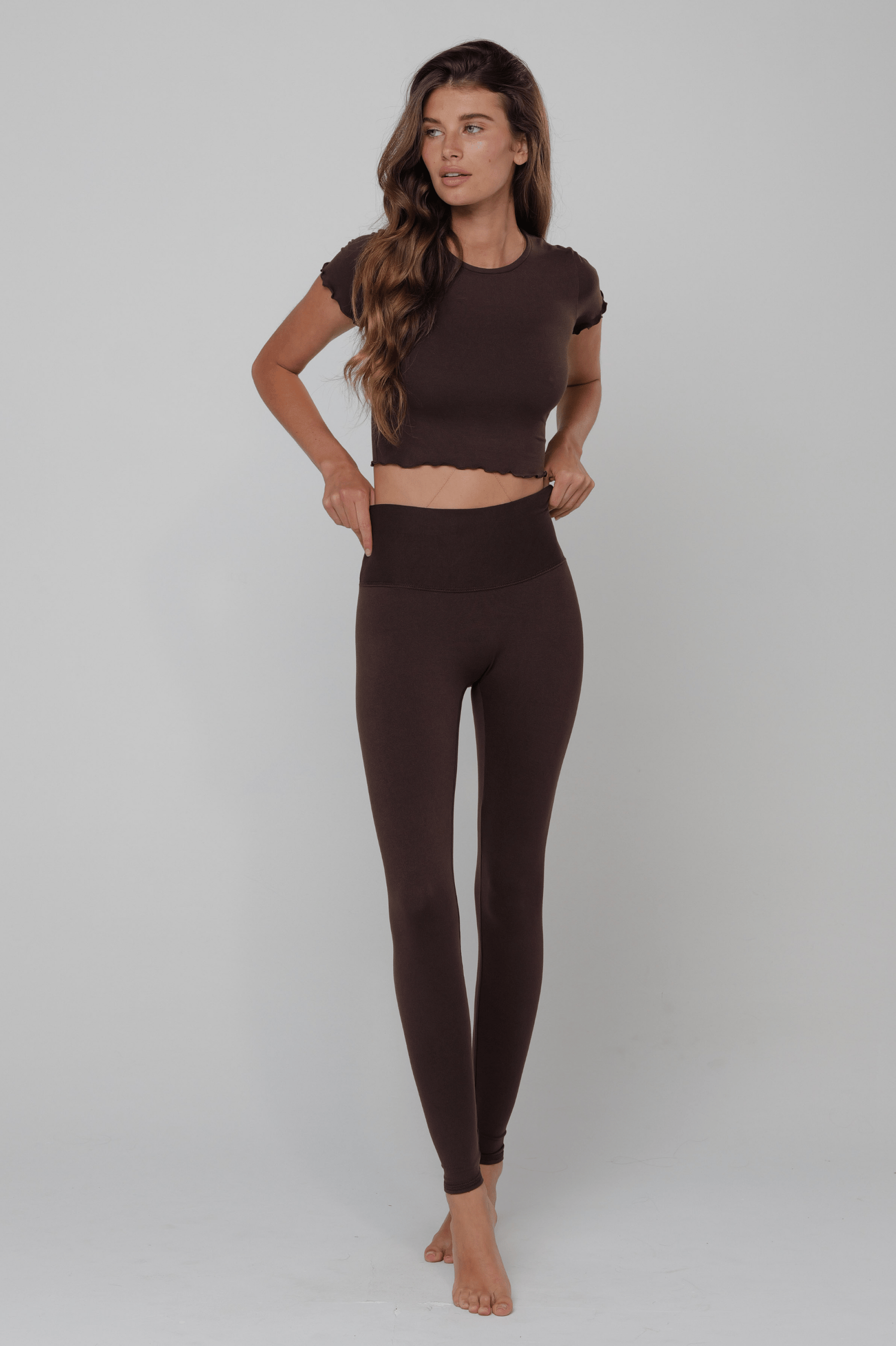 This is an image of Legging in Second Skin Cacao - RESA featuring a model wearing the dress