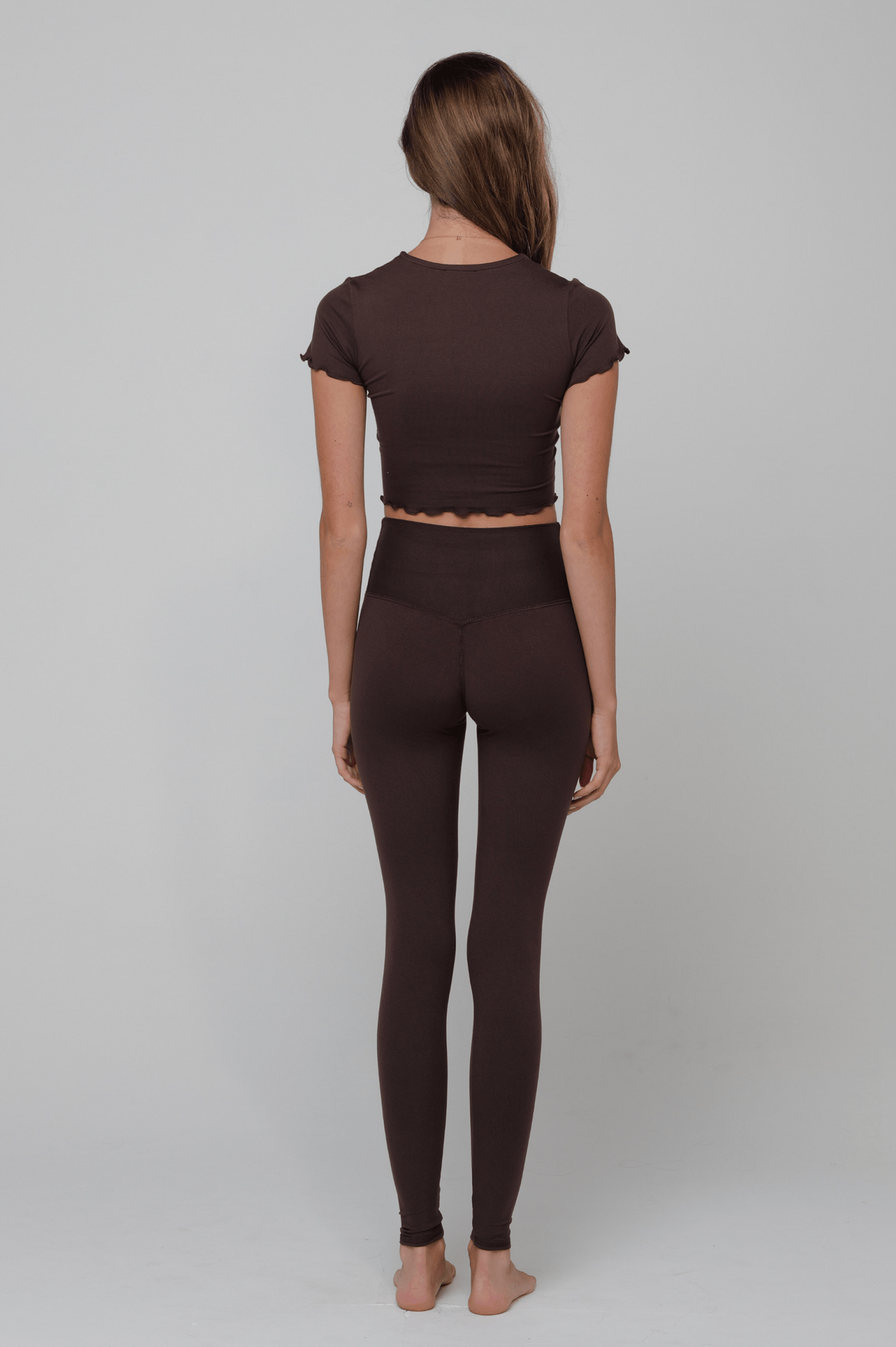 This is an image of Legging in Second Skin Cacao - RESA featuring a model wearing the dress