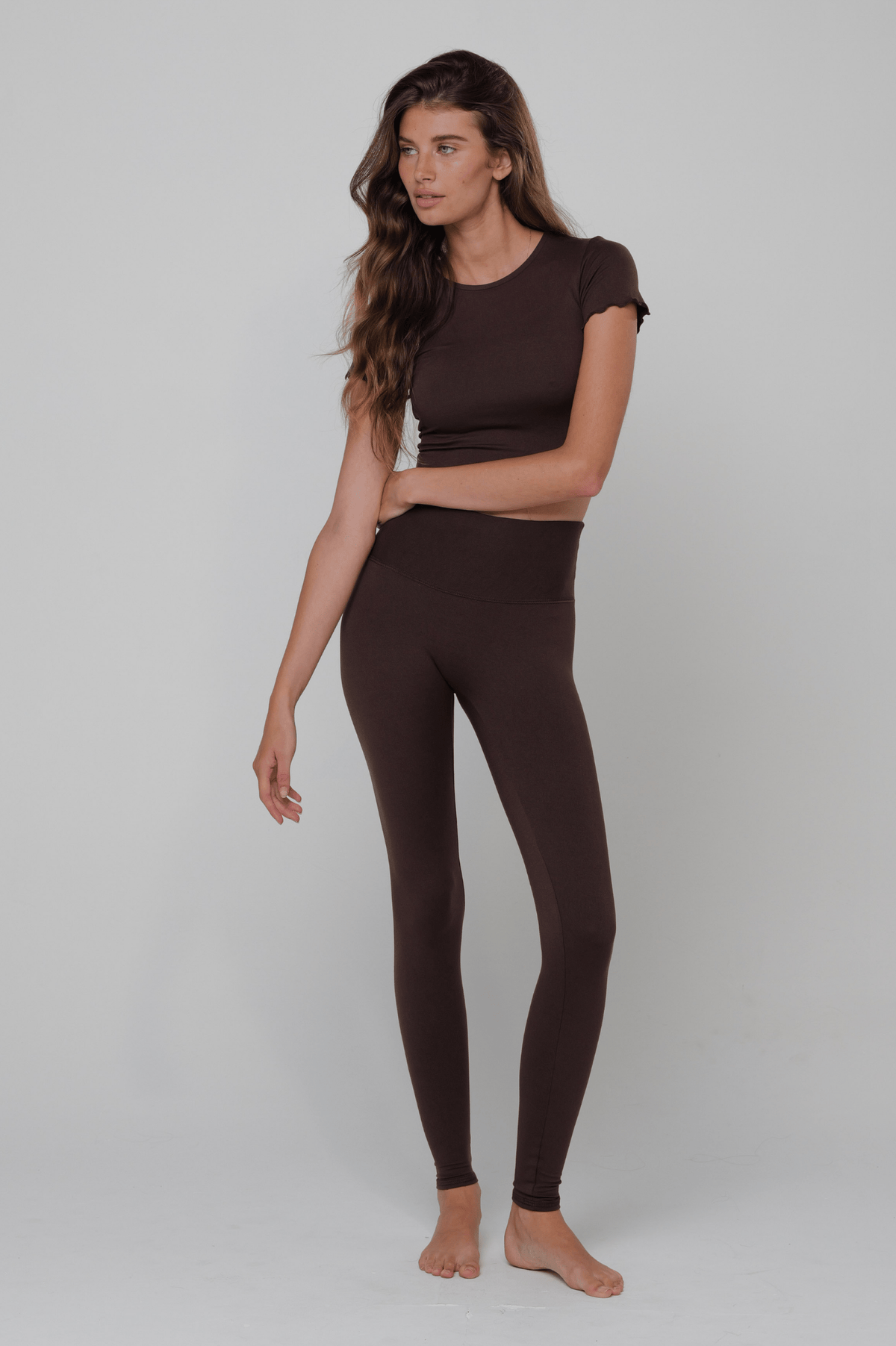 This is an image of Legging in Second Skin Cacao - RESA featuring a model wearing the dress
