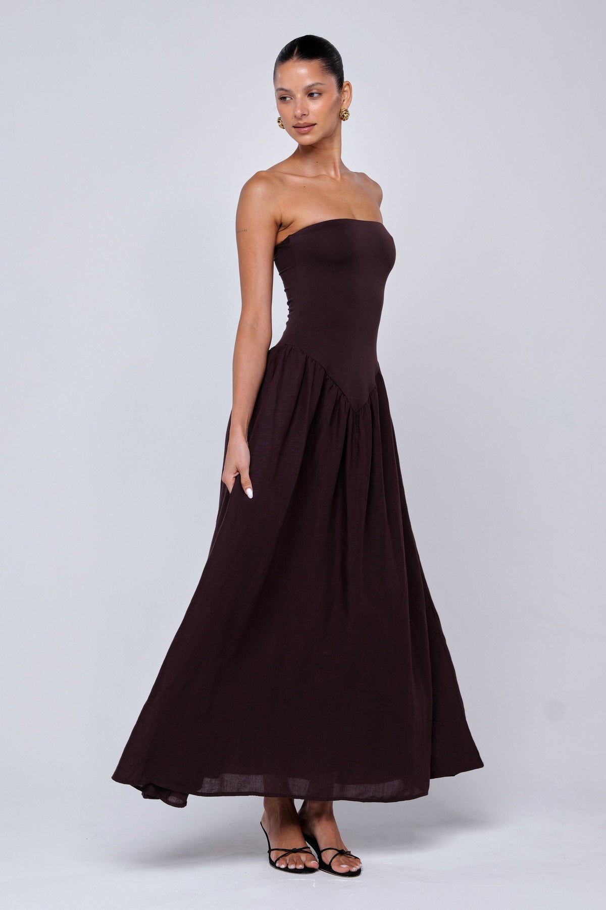 This is an image of Mackenzie Dress in Brown Linen - RESA featuring a model wearing the dress