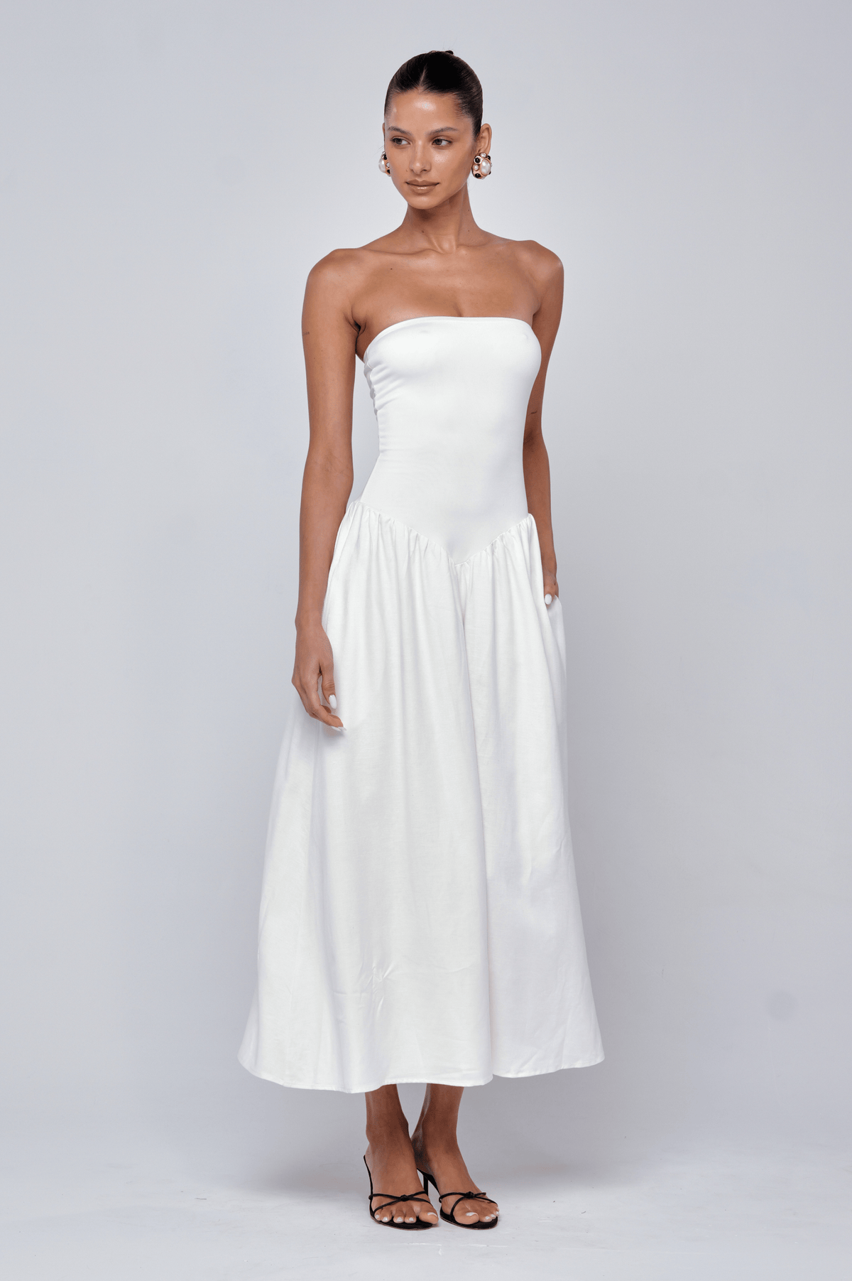 This is an image of Mackenzie Dress in White Linen - RESA featuring a model wearing the dress