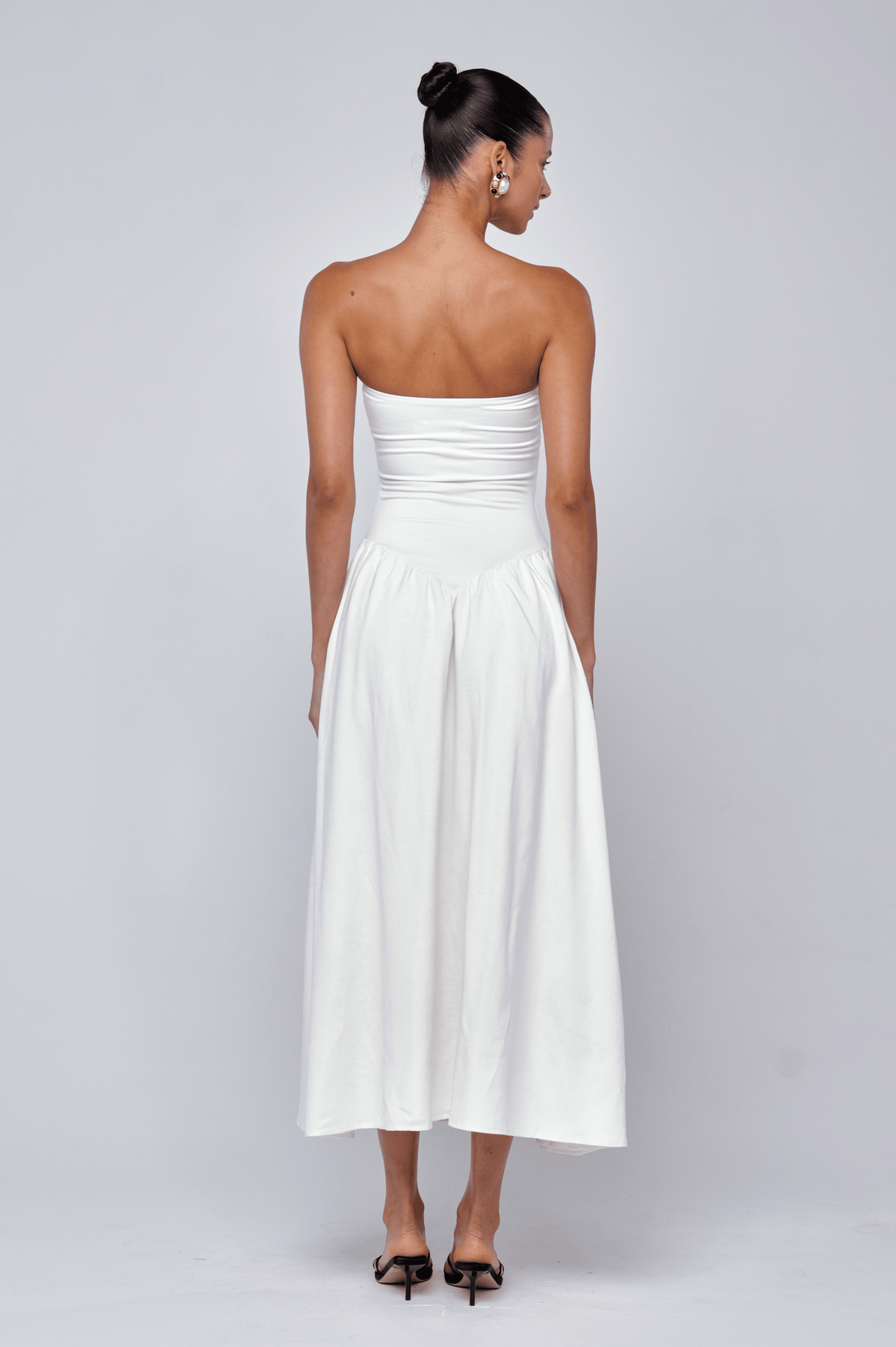 This is an image of Mackenzie Dress in White Linen - RESA featuring a model wearing the dress