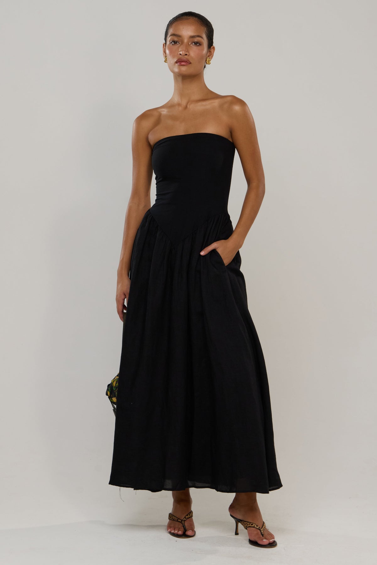 This is an image of Mackenzie in Black Linen - RESA featuring a model wearing the dress
