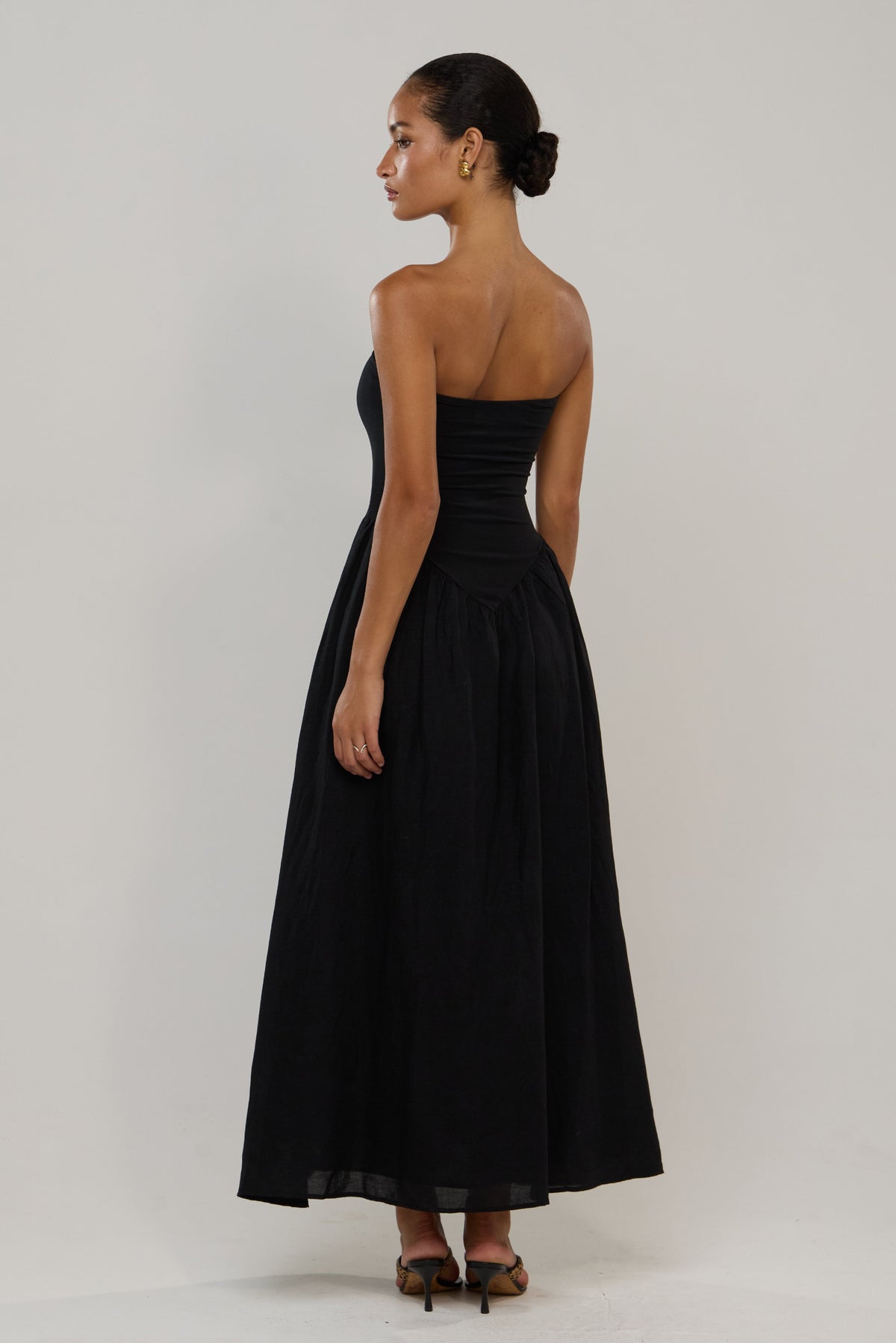 This is an image of Mackenzie in Black Linen - RESA featuring a model wearing the dress