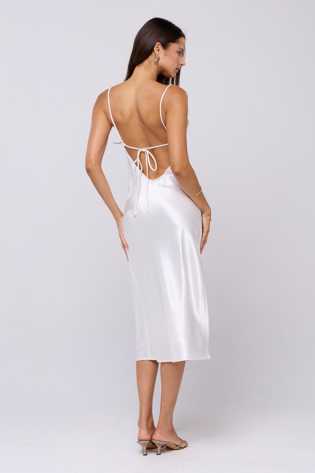 This is an image of Madison Slip in Pearl - RESA featuring a model wearing the dress