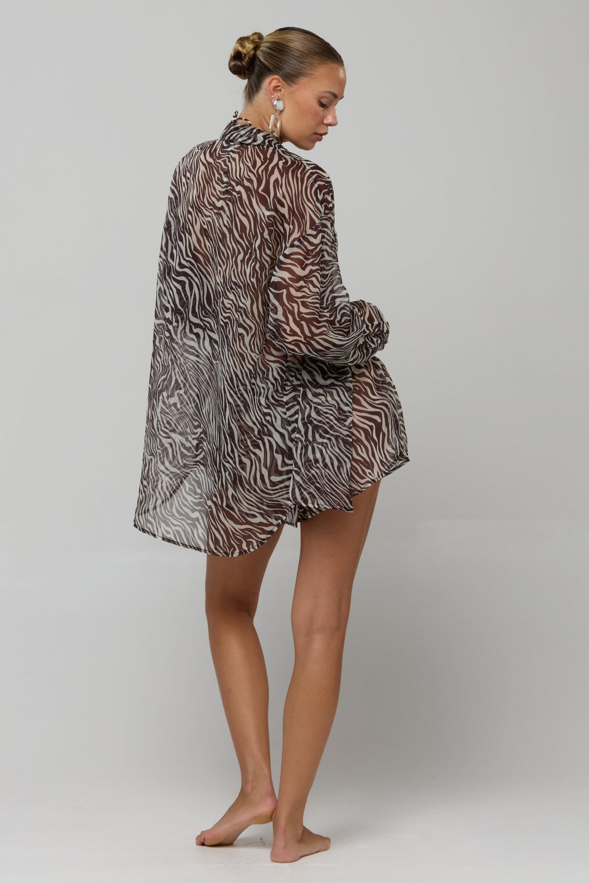 This is an image of Maggie set in Selva - RESA featuring a model wearing the dress