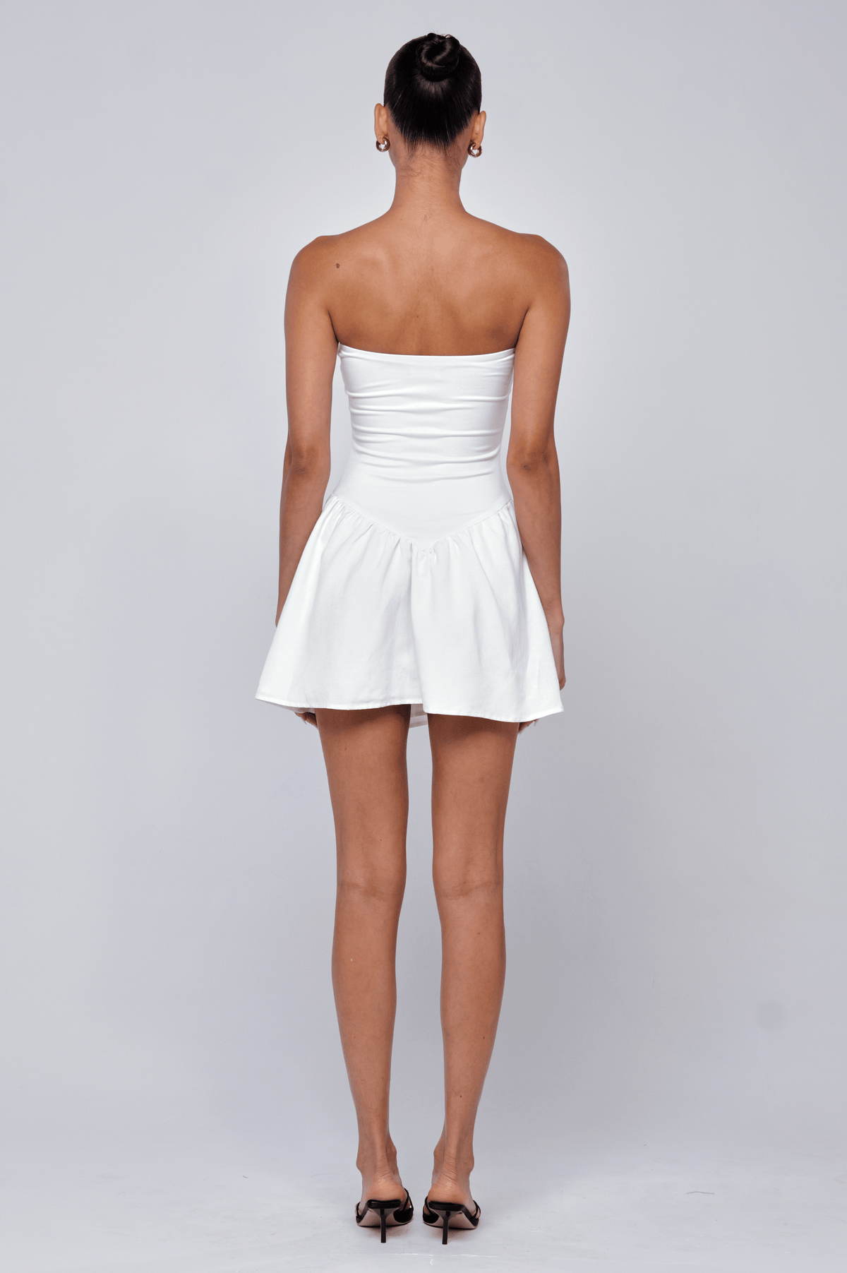This is an image of Makie Dress White Linen - RESA featuring a model wearing the dress