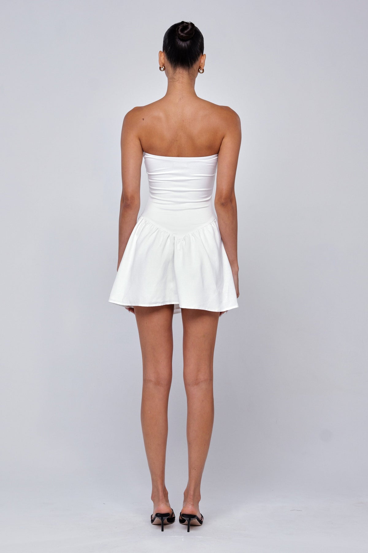 This is an image of Makie Dress White Linen - RESA featuring a model wearing the dress