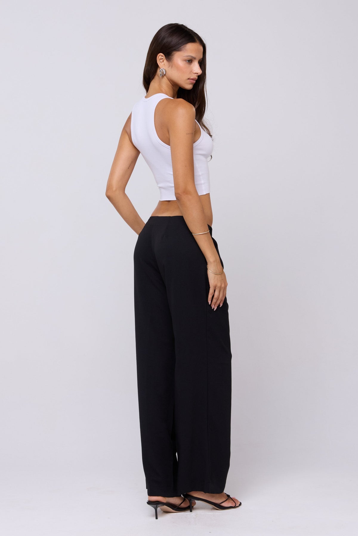 This is an image of Malcolm Trousers in Black - RESA featuring a model wearing the dress