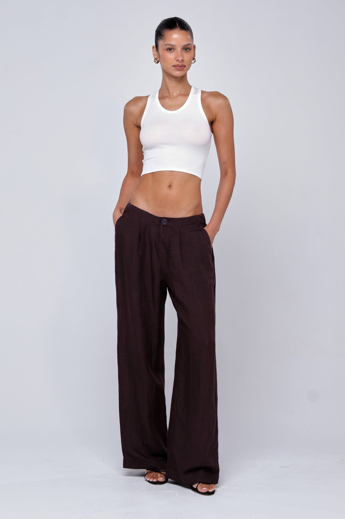 This is an image of Malcolm Trousers in Brown Linen - RESA featuring a model wearing the dress