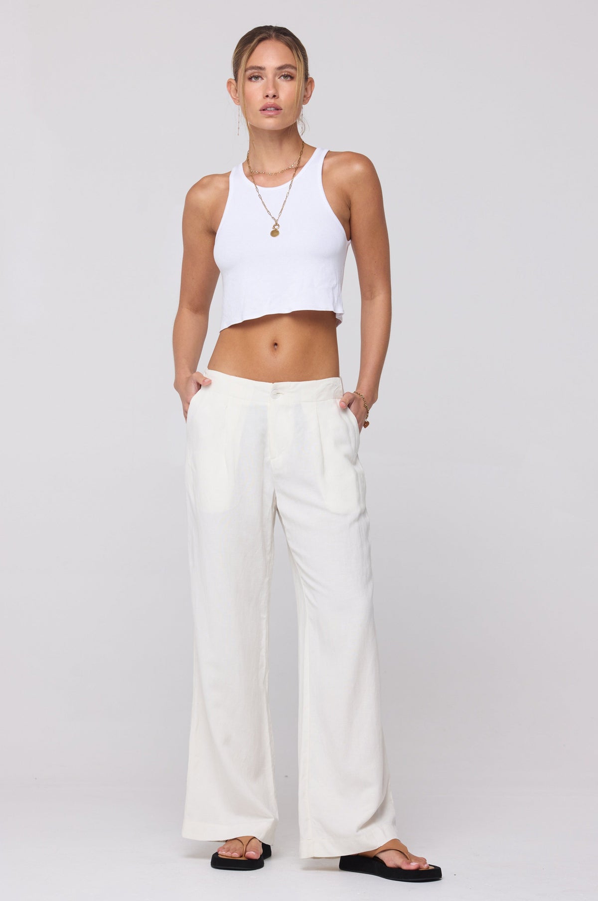 This is an image of Malcolm Trousers in White Linen - RESA featuring a model wearing the dress