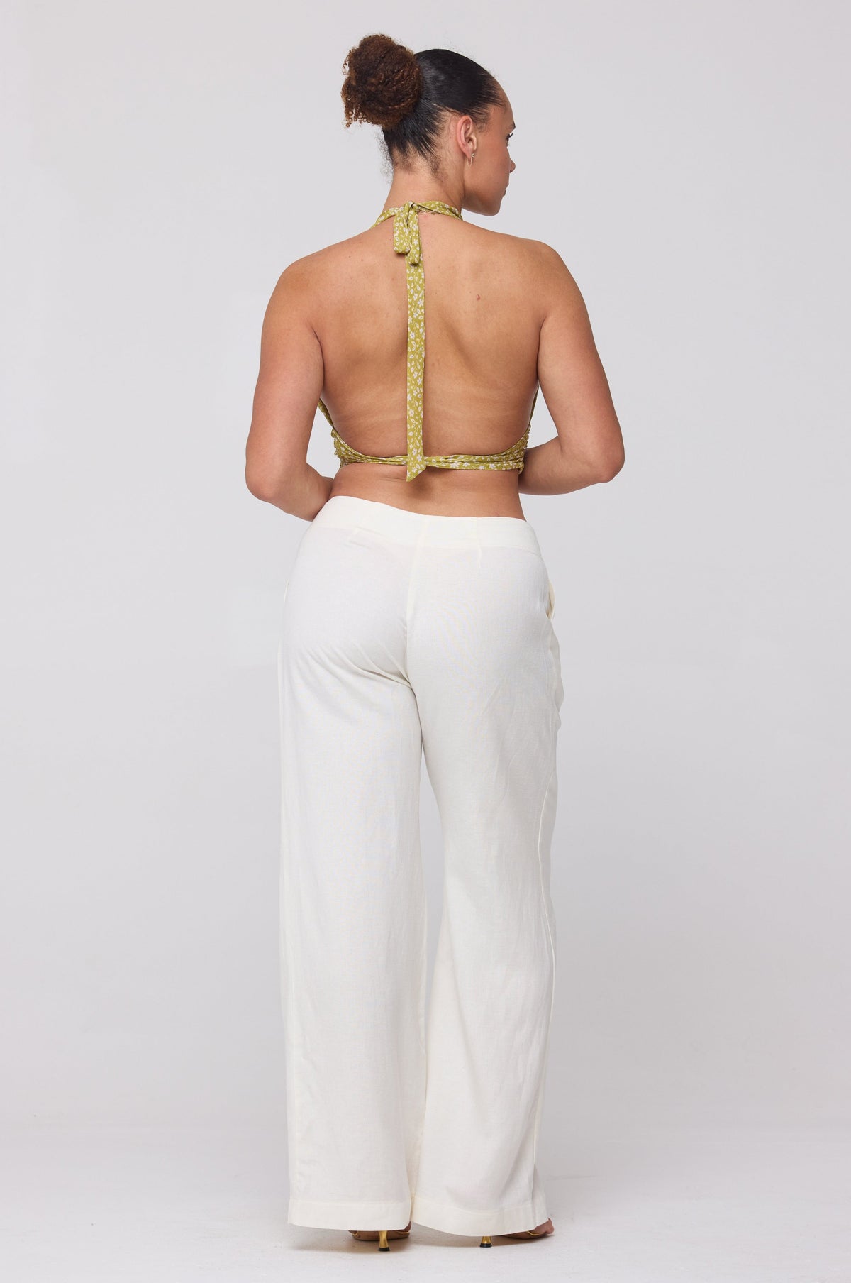 This is an image of Malcolm Trousers in White Linen - RESA featuring a model wearing the dress