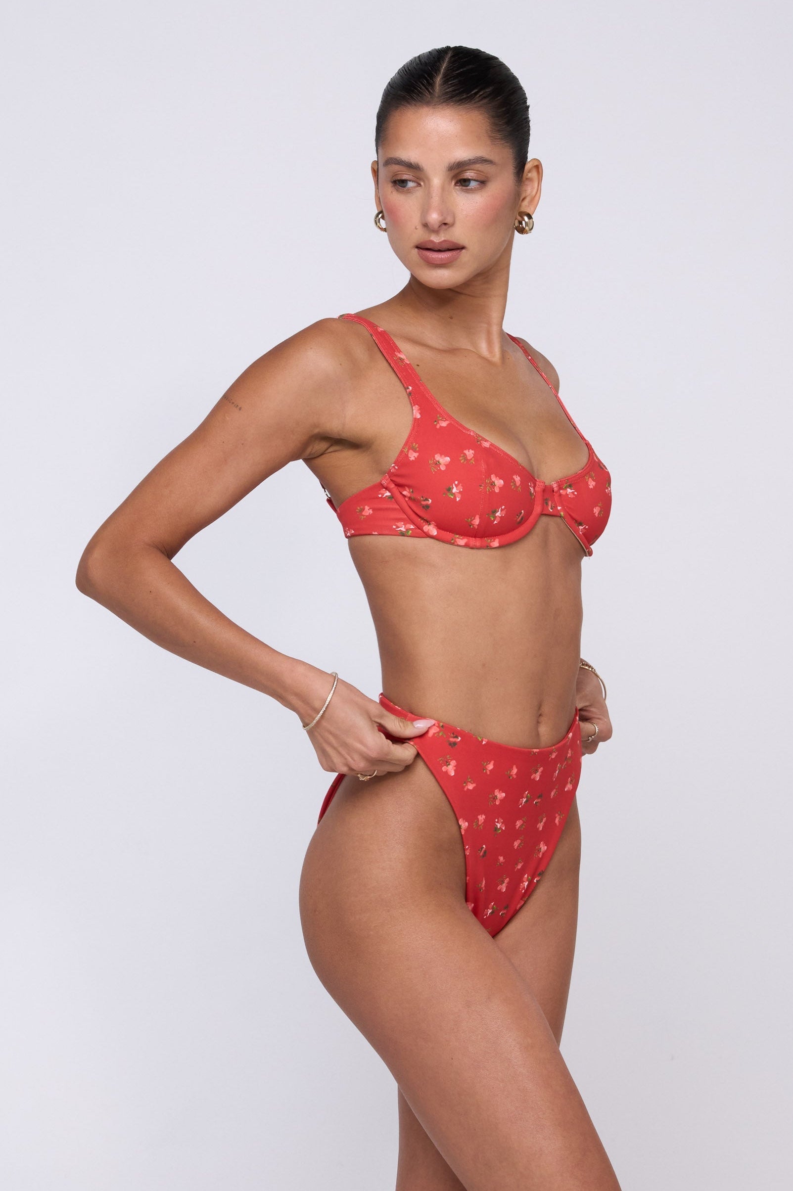This is an image of Matty Bikini Top in Cayenne - RESA featuring a model wearing the dress