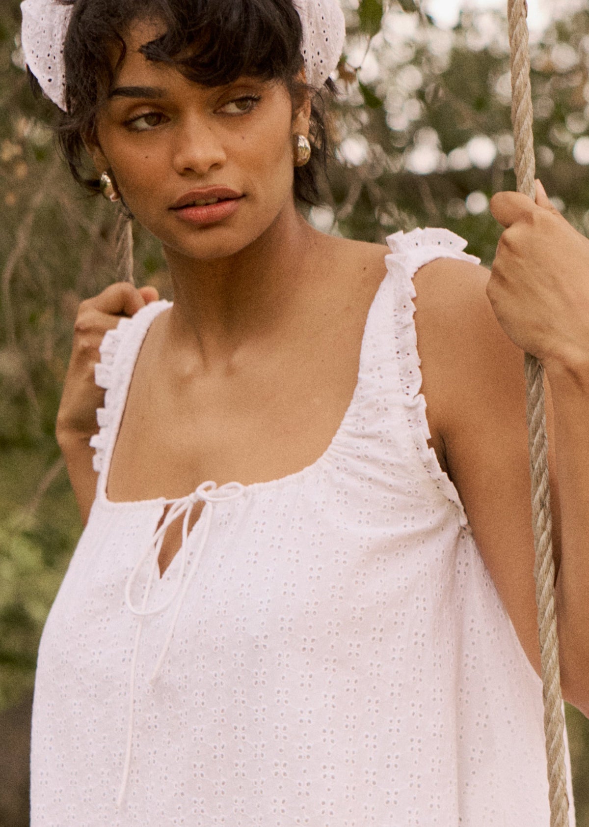 This is an image of Mini Moo Dress in White Eyelet - RESA featuring a model wearing the dress