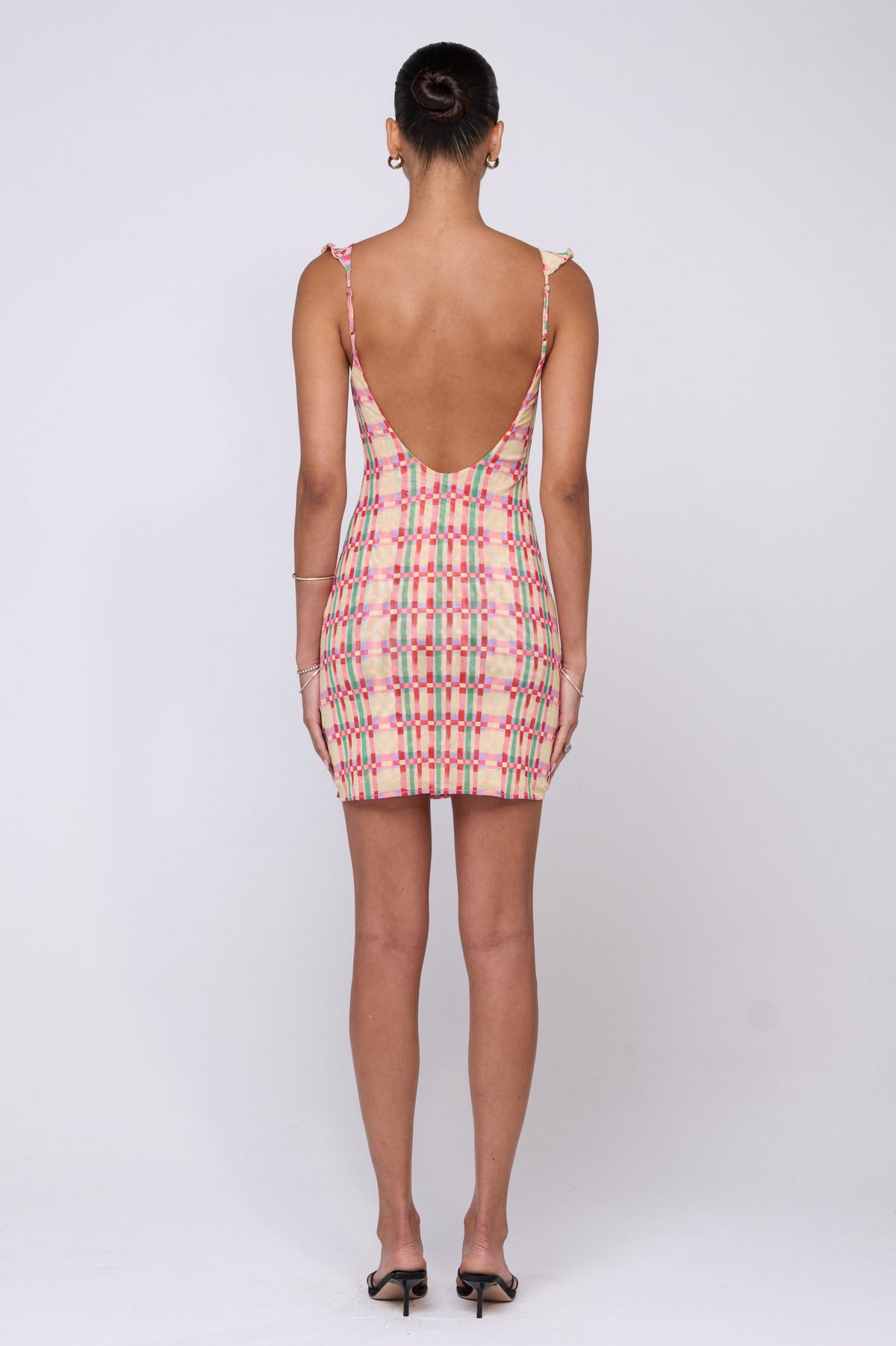 This is an image of Reese Mini in Plaid - RESA featuring a model wearing the dress