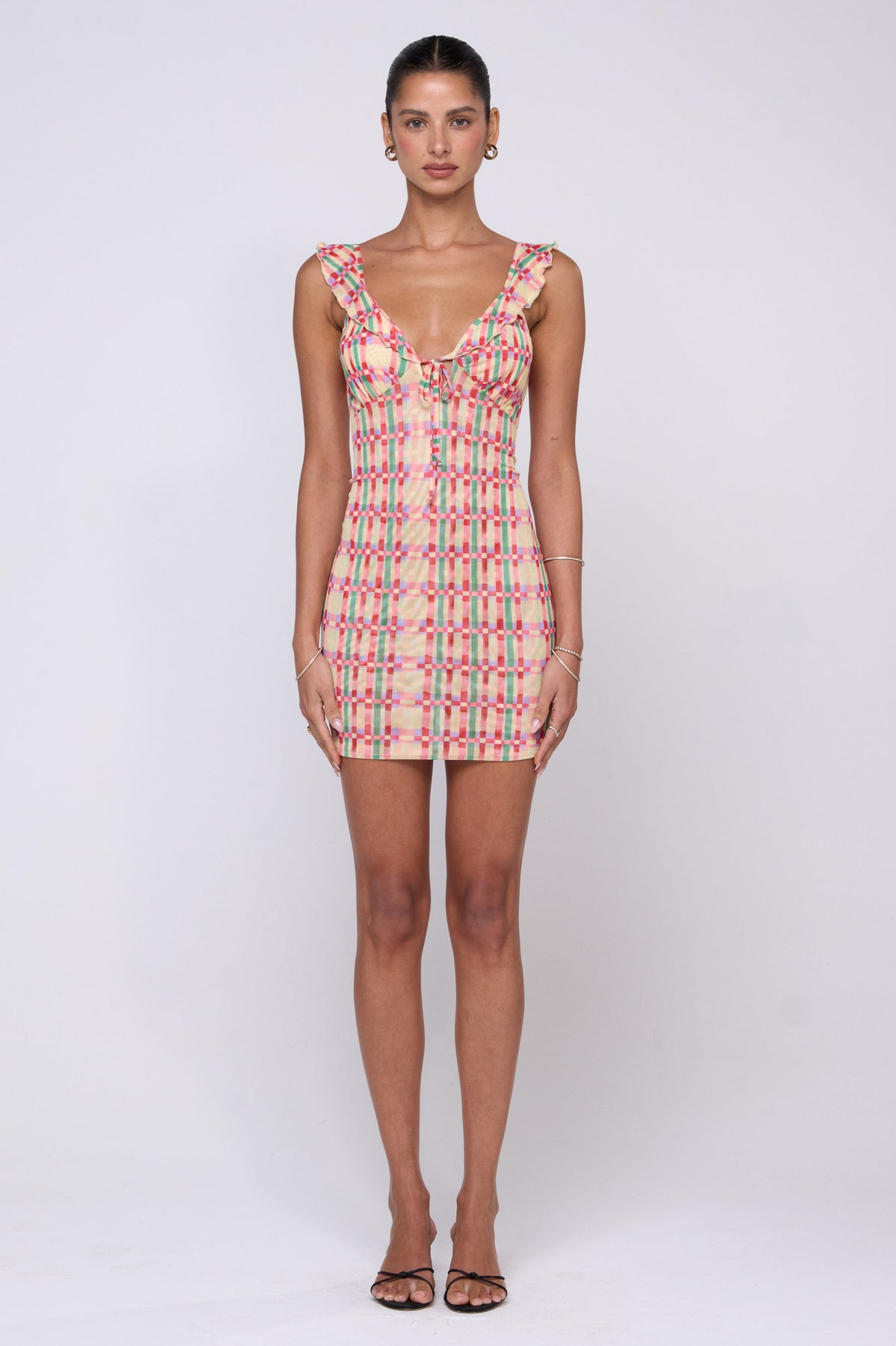 This is an image of Reese Mini in Plaid - RESA featuring a model wearing the dress