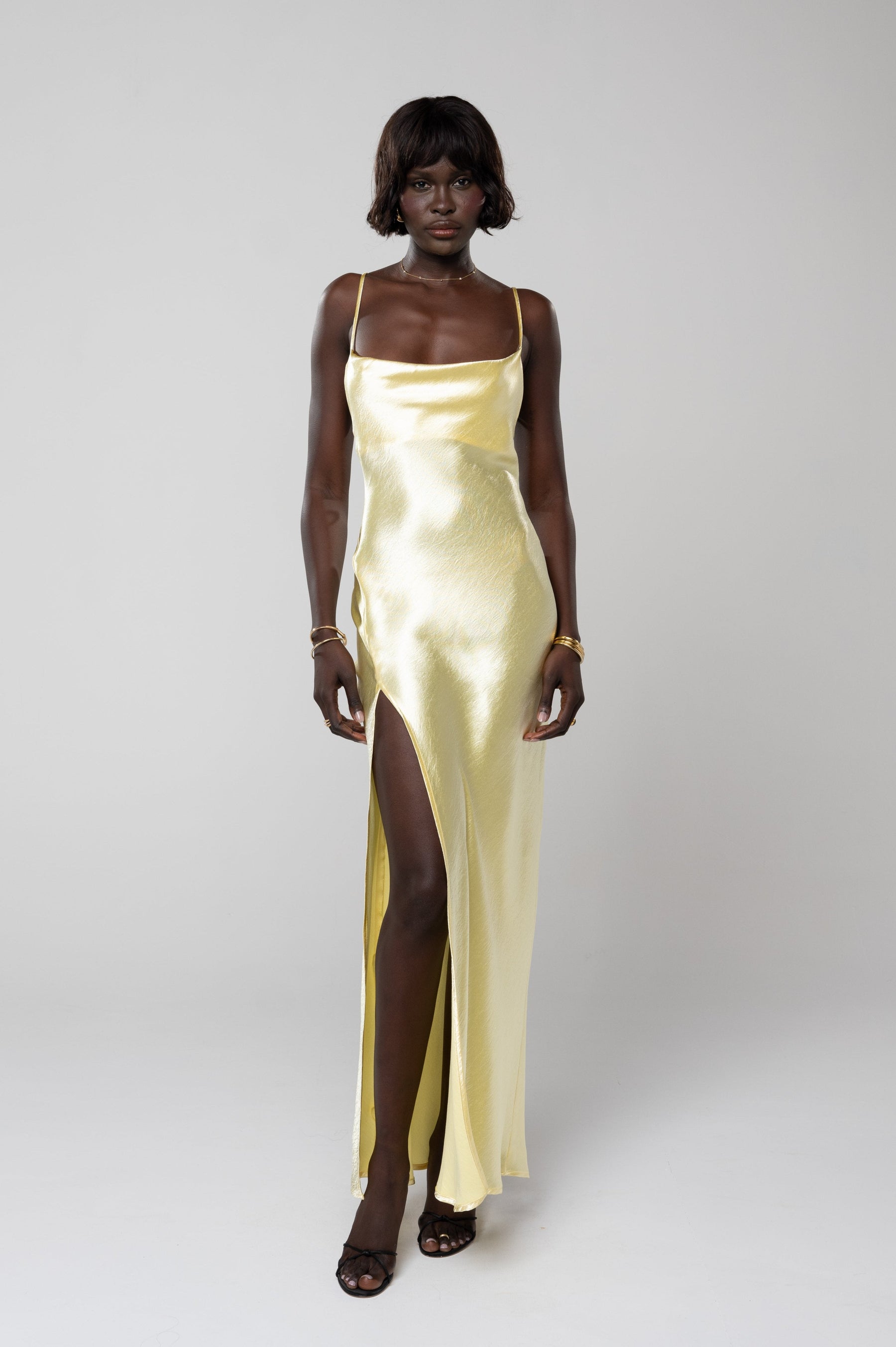 This is an image of River Slip in Butter - RESA featuring a model wearing the dress