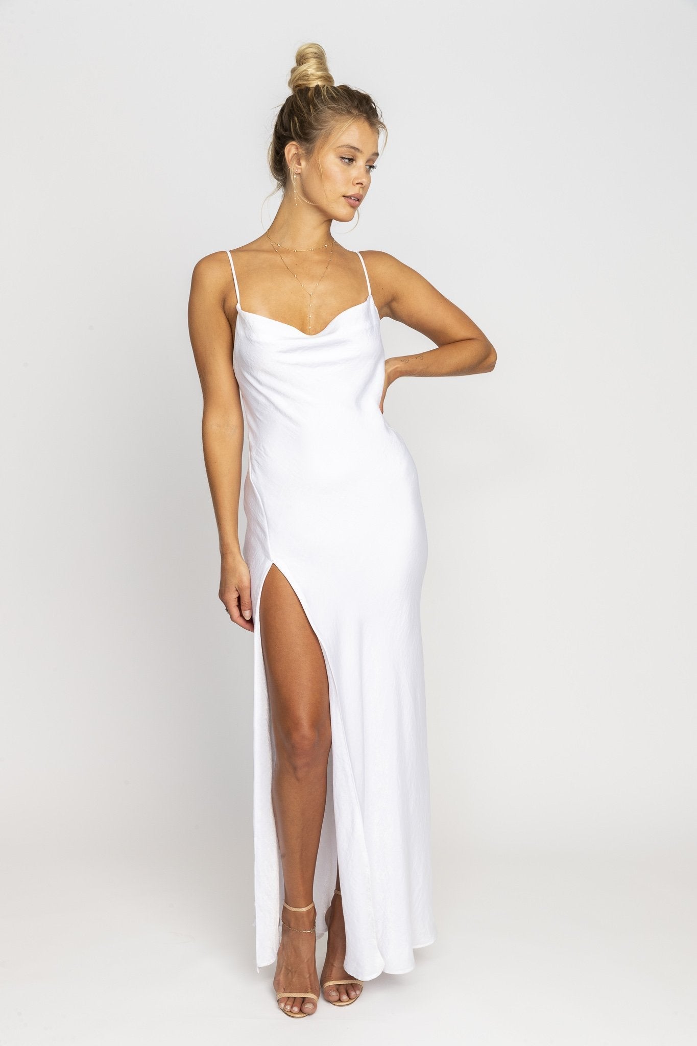 This is an image of RIVER SLIP IN IVORY - SAMPLE SALE - RESA featuring a model wearing the dress