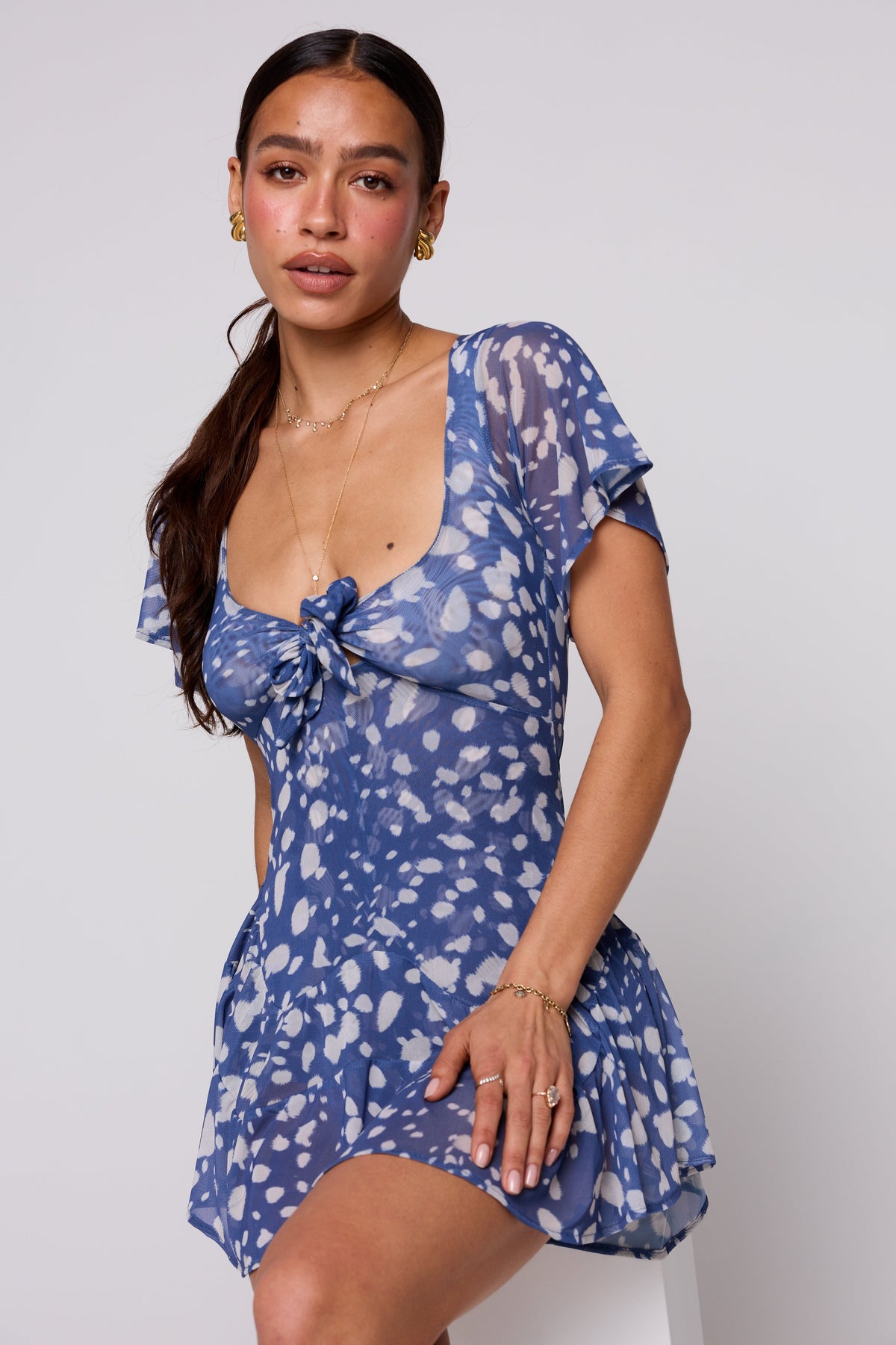 This is an image of Romy Romper in Cove - RESA featuring a model wearing the dress