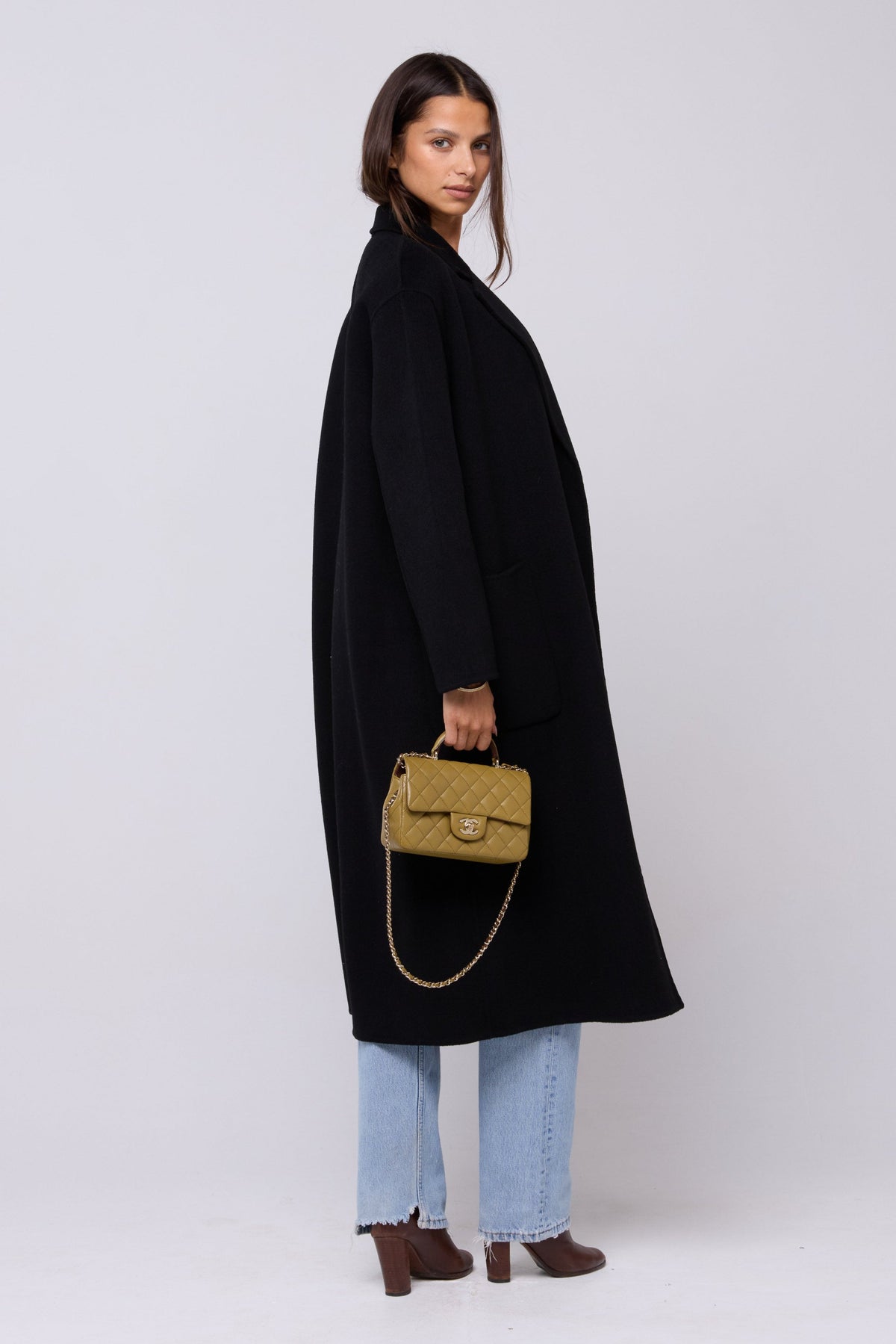 This is an image of Ryder Coat in Black - RESA featuring a model wearing the dress