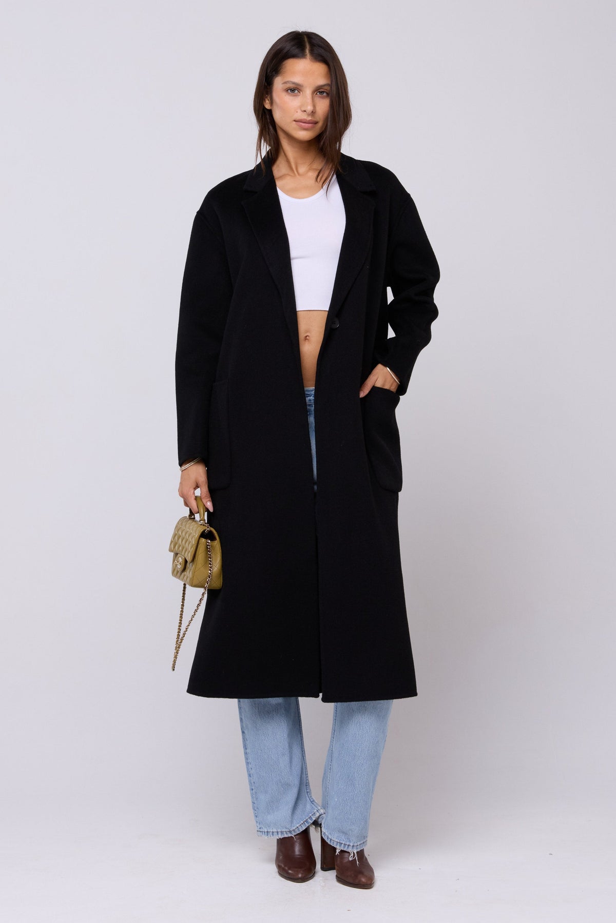 This is an image of Ryder Coat in Black - RESA featuring a model wearing the dress