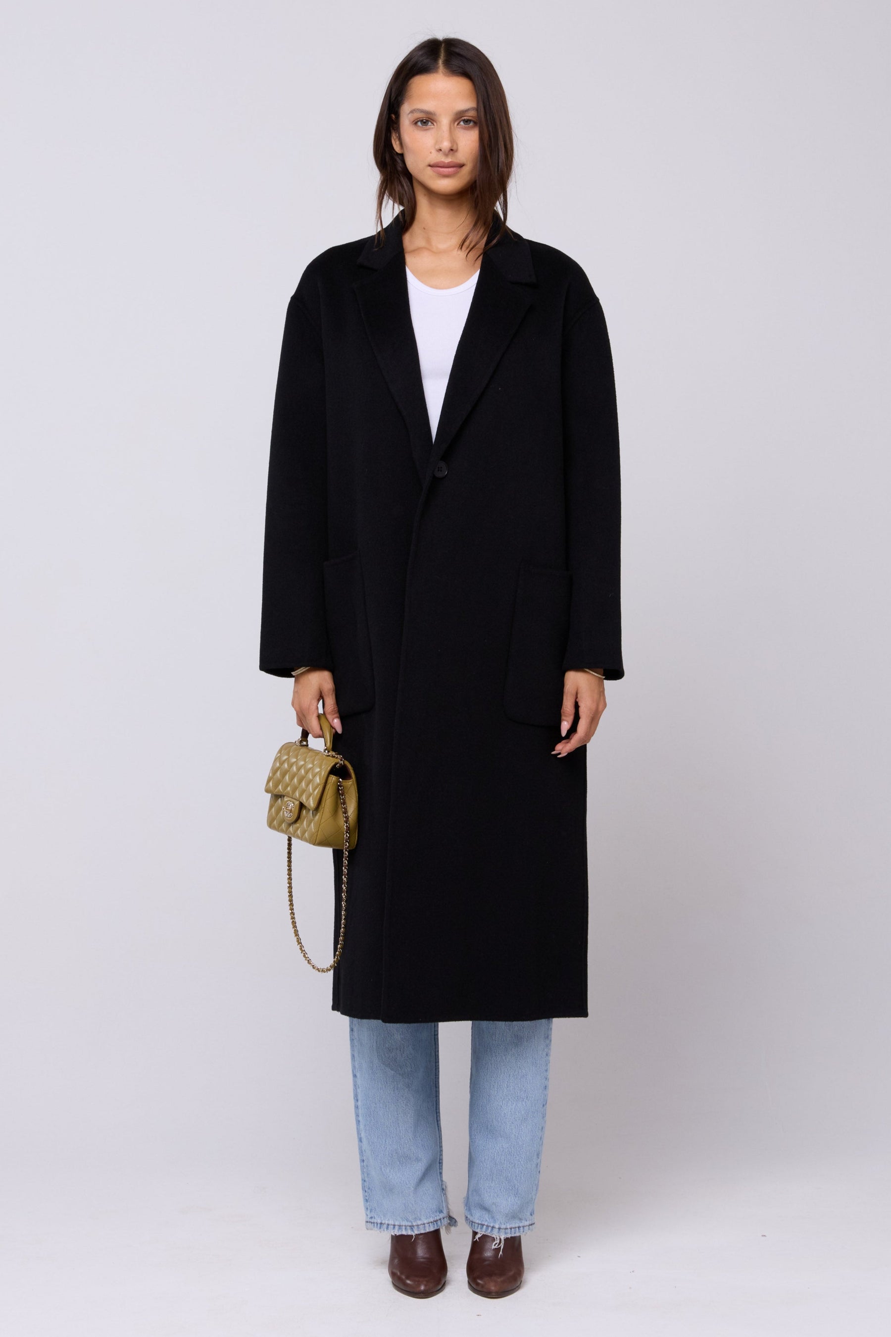 This is an image of Ryder Coat in Black - RESA featuring a model wearing the dress