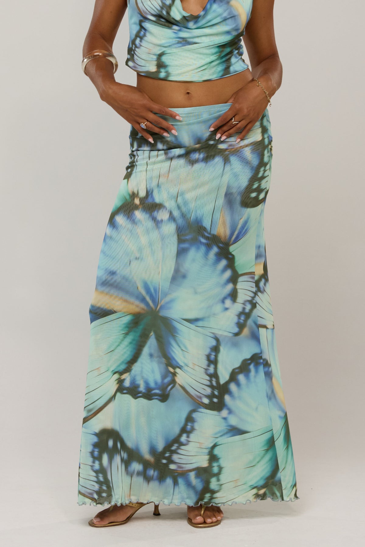 This is an image of Sarah in Mariposa - RESA featuring a model wearing the dress
