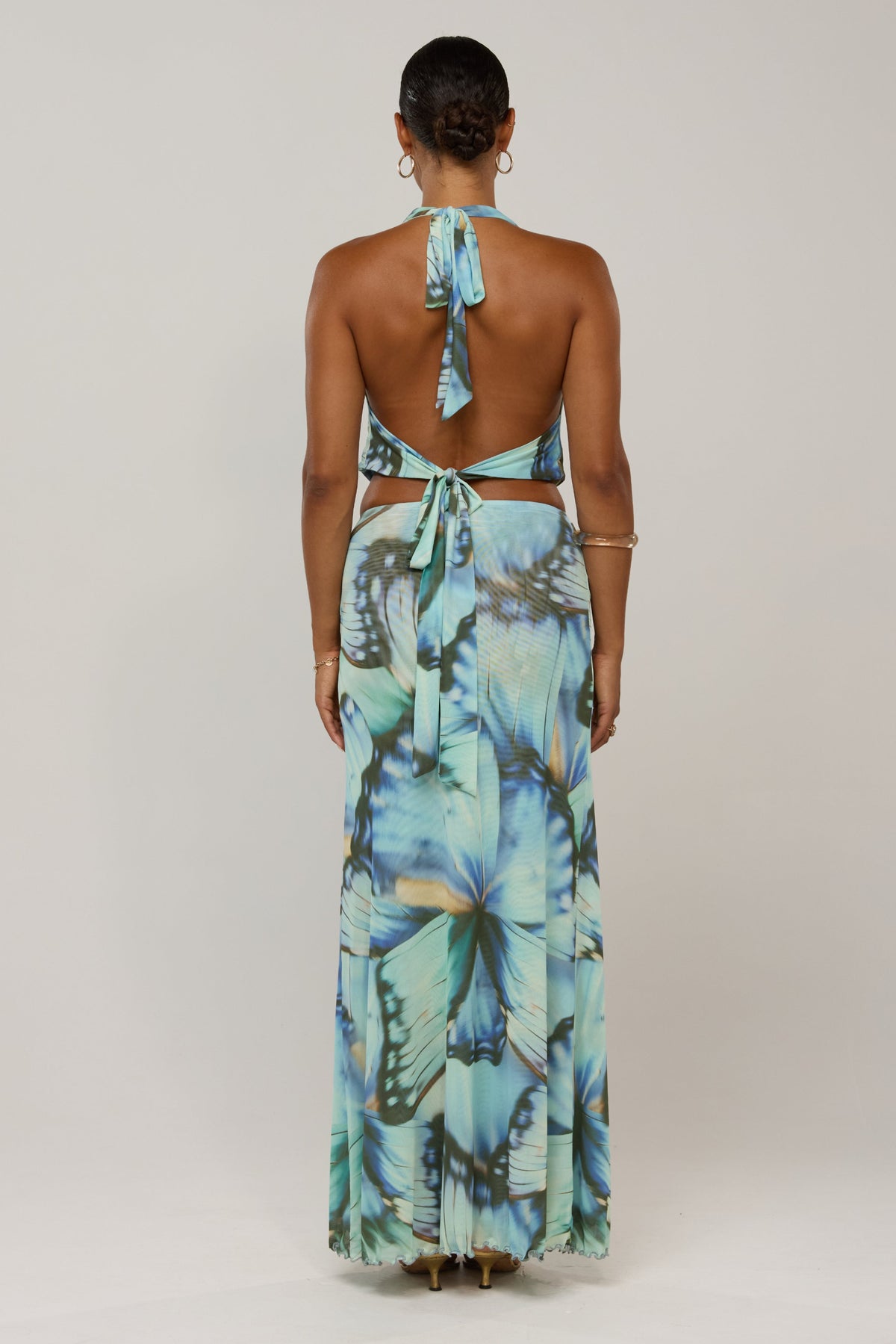 This is an image of Sarah in Mariposa - RESA featuring a model wearing the dress