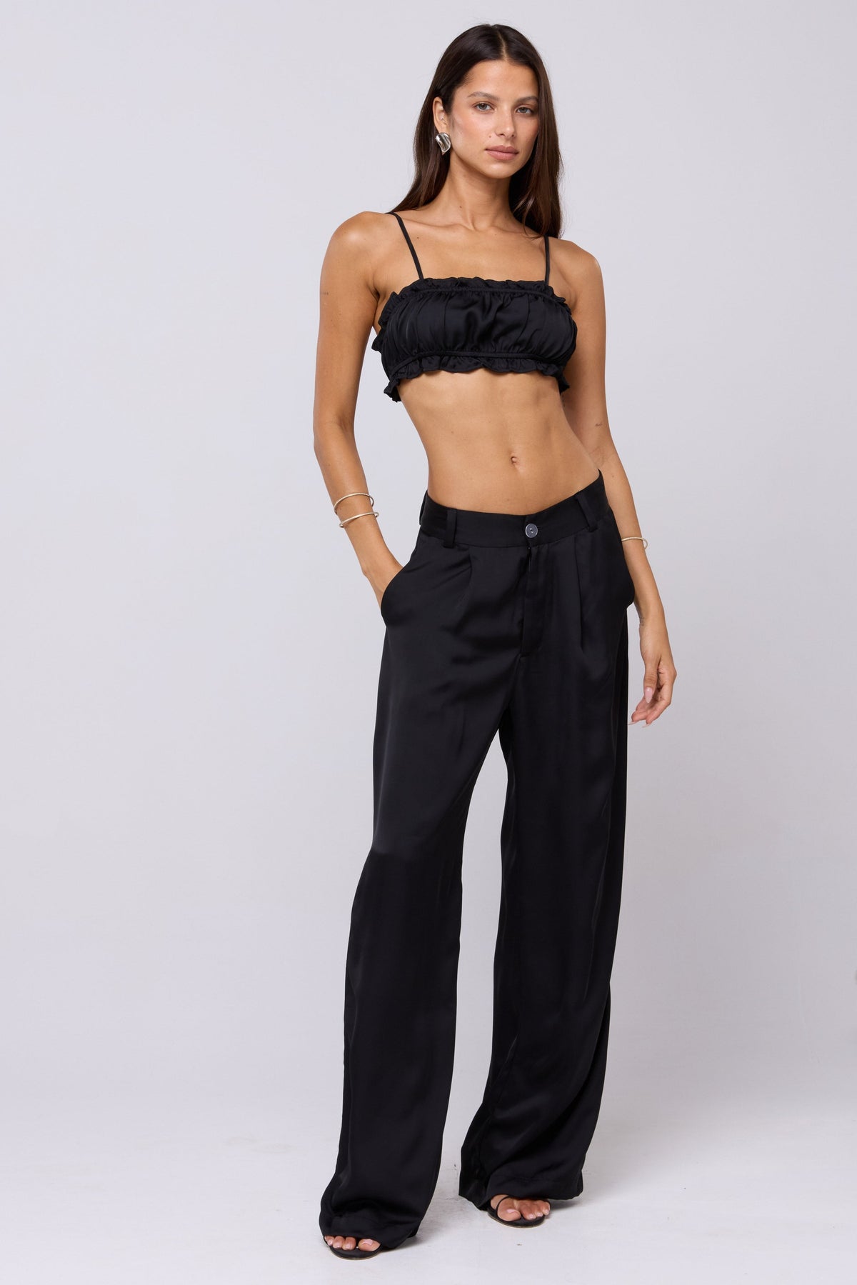 This is an image of Sasha Trouser in Black - RESA featuring a model wearing the dress