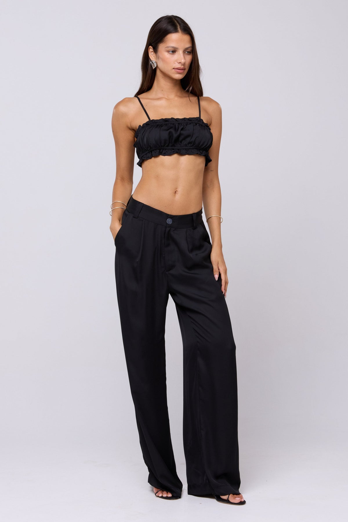 This is an image of Sasha Trouser in Black - RESA featuring a model wearing the dress