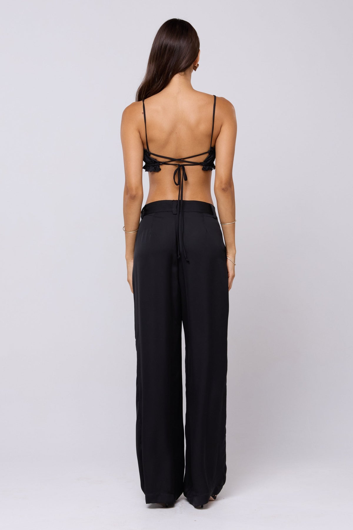 This is an image of Sasha Trouser in Black - RESA featuring a model wearing the dress
