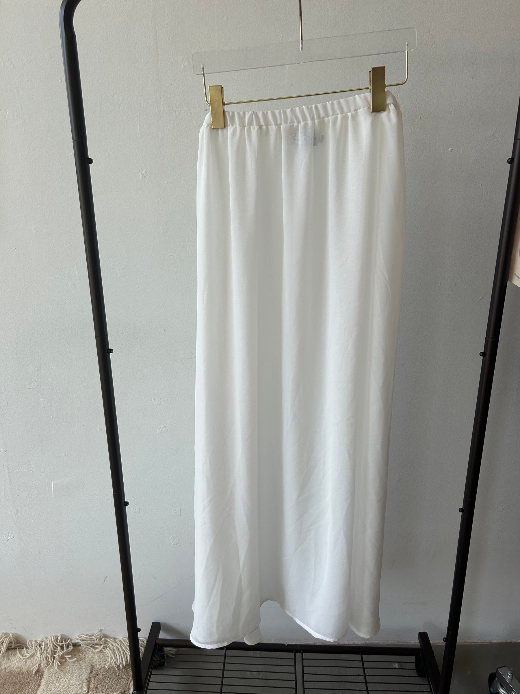 This is an image of SHEER WHITE MAXI SKIRT- SAMPLE SALE - RESA featuring a model wearing the dress