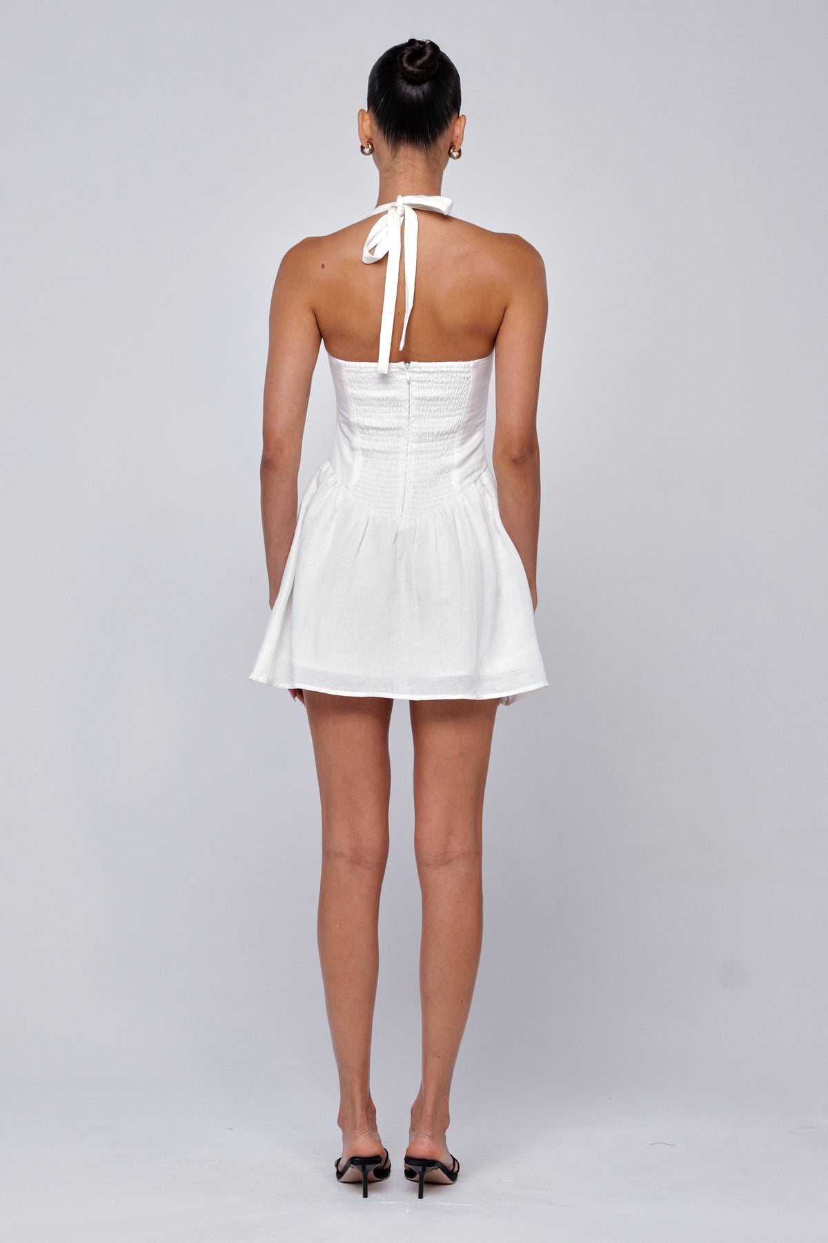 This is an image of Sutton Mini Dress in White Linen - RESA featuring a model wearing the dress