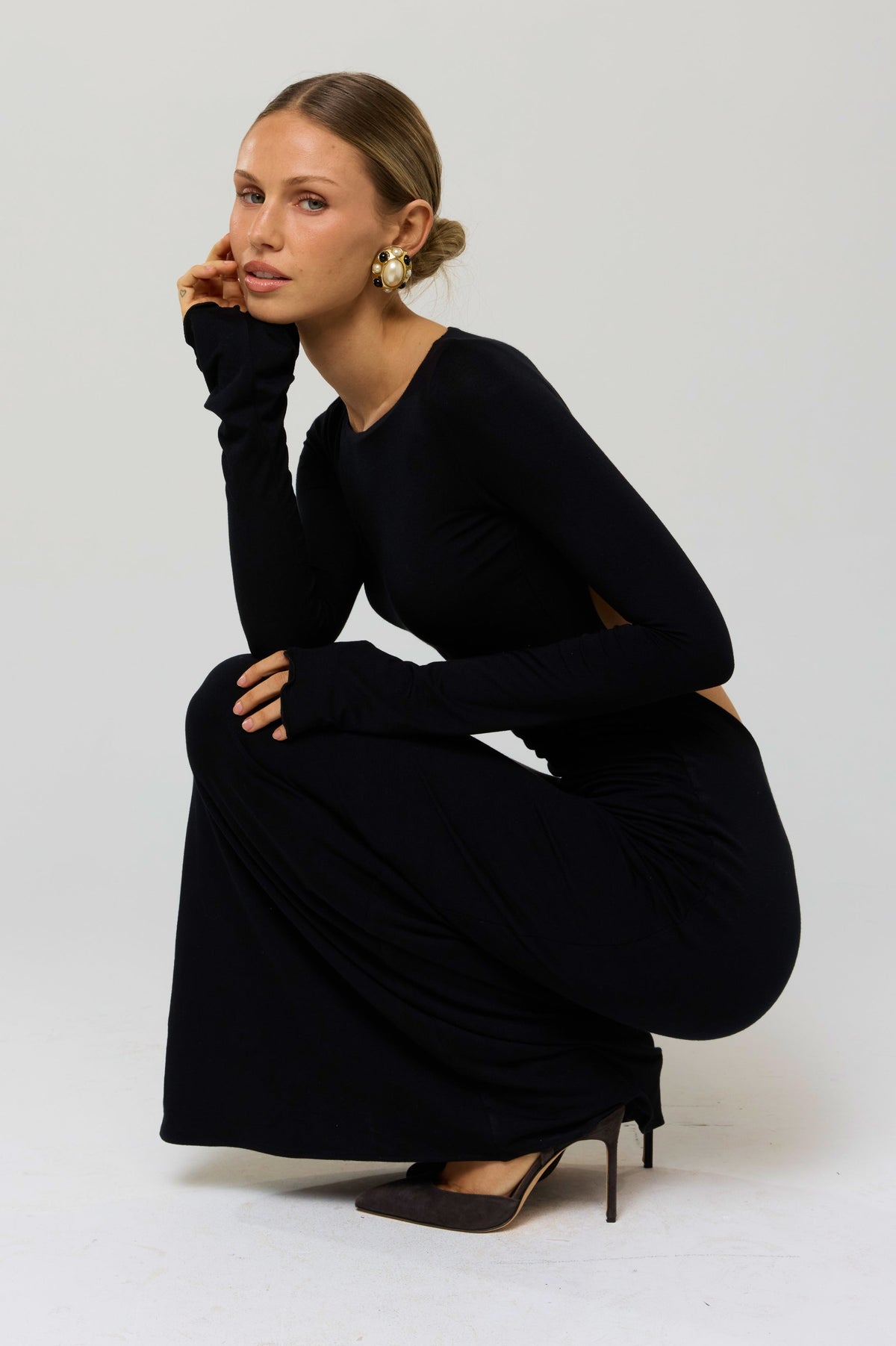 This is an image of Sylvia Dress in Black Knit - RESA featuring a model wearing the dress
