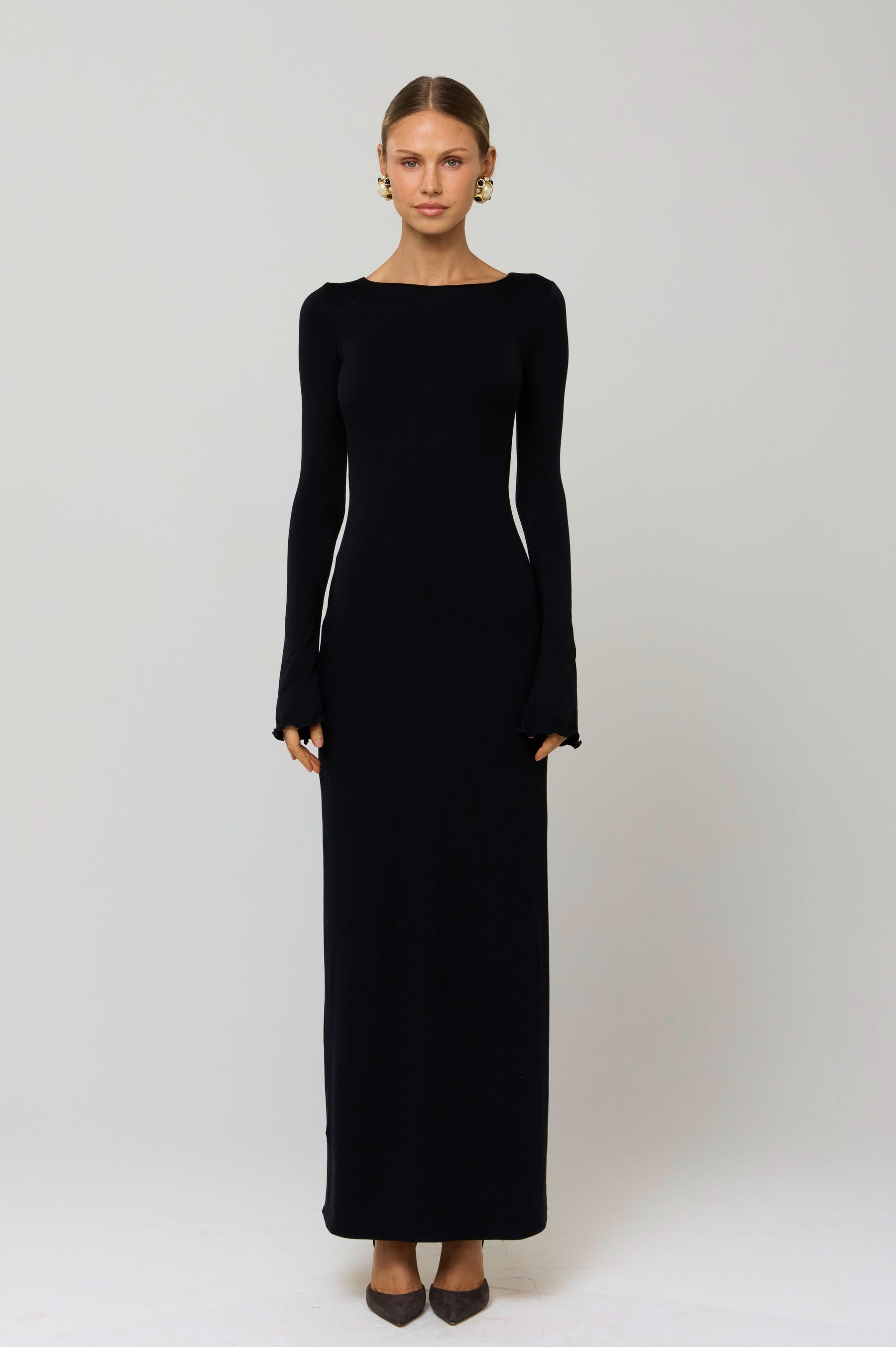 This is an image of Sylvia Dress in Black Knit - RESA featuring a model wearing the dress