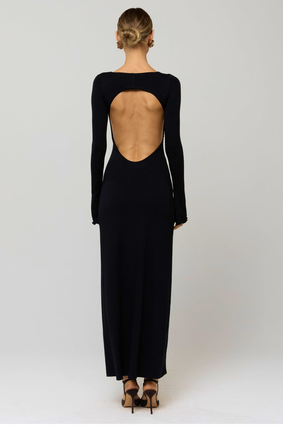 This is an image of Sylvia Dress in Black Knit - RESA featuring a model wearing the dress