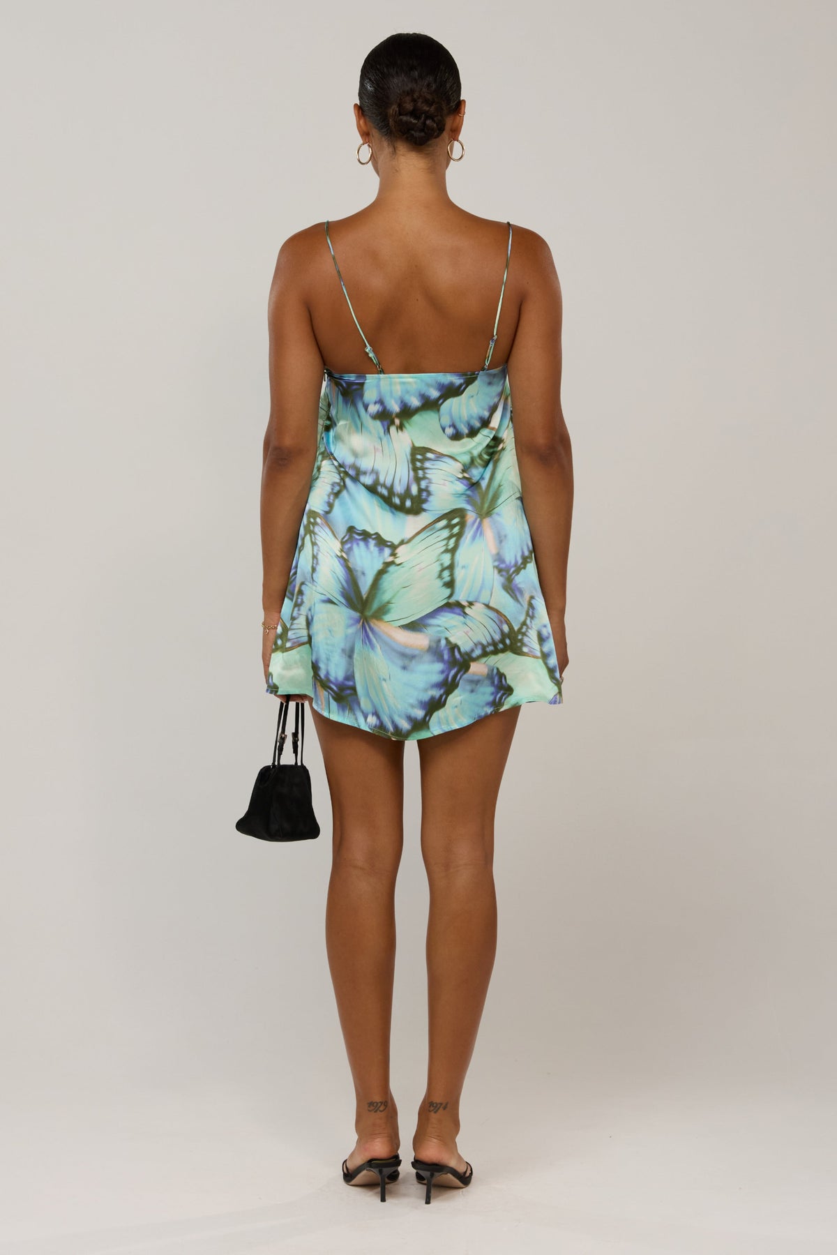This is an image of Vivi in Mariposa - RESA featuring a model wearing the dress