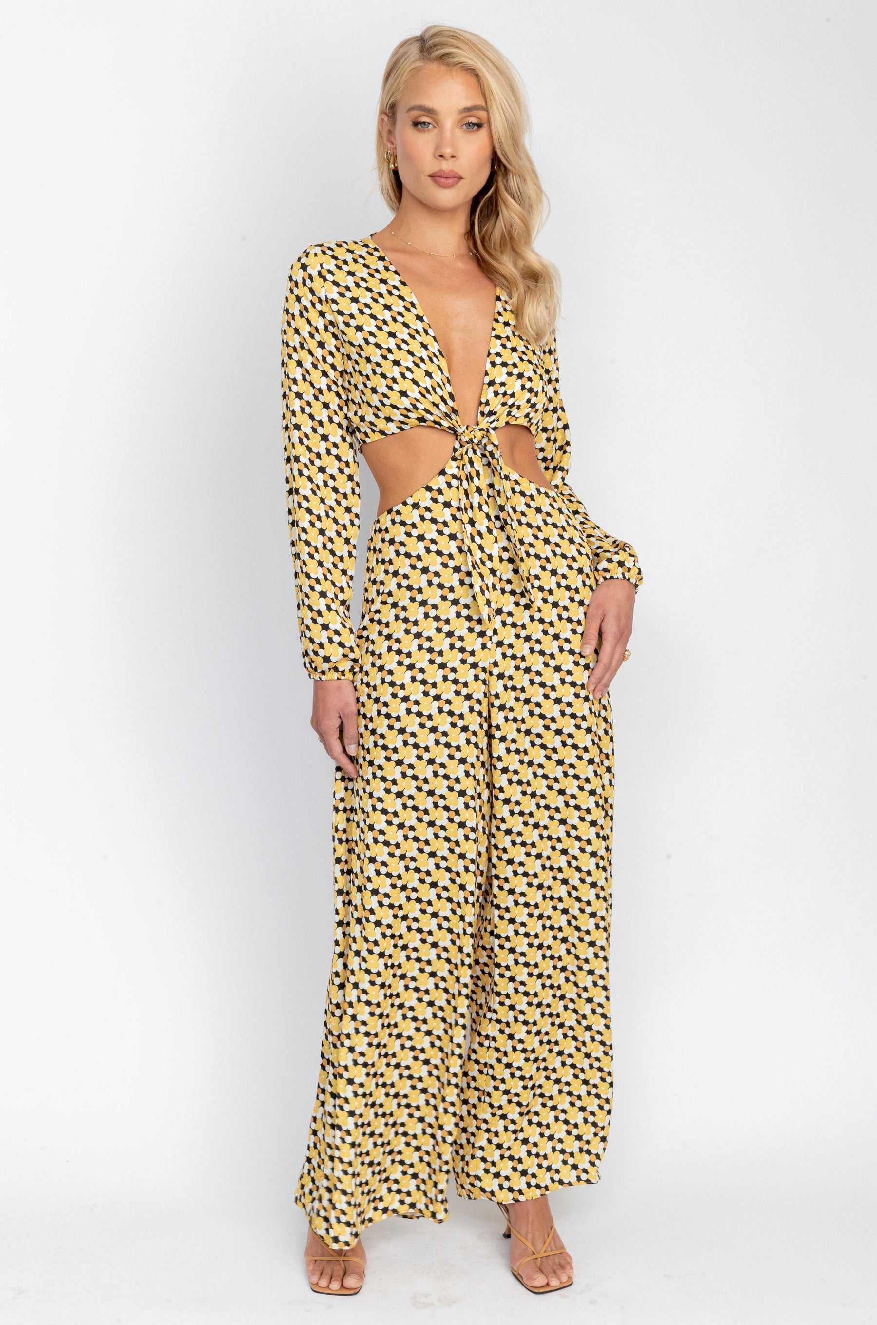 This is an image of ZOE JUMPSUIT IN TWIGGY - SAMPLE SALE - RESA featuring a model wearing the dress