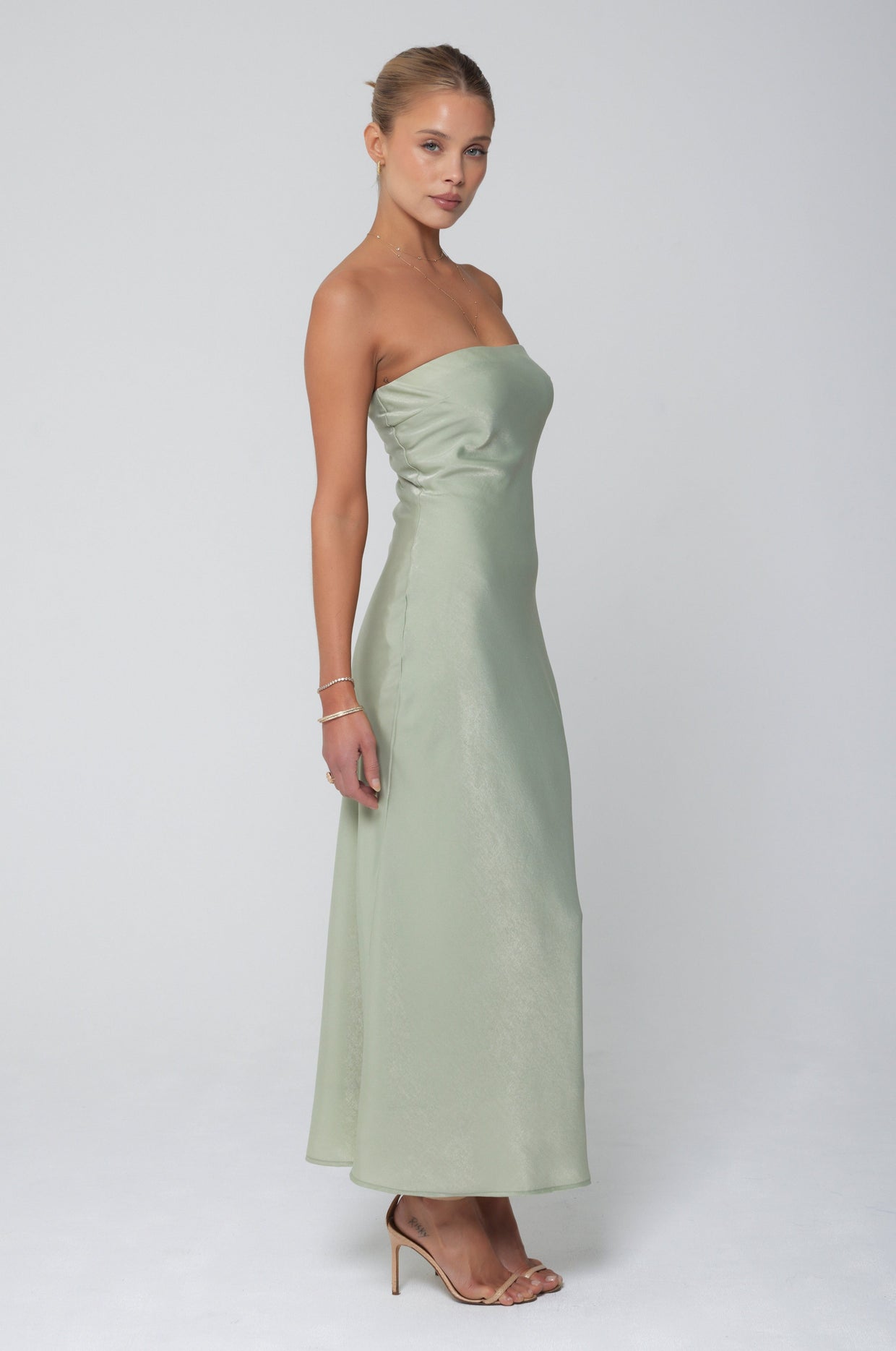 This is an image of Anna Slip in Sage - RESA featuring a model wearing the dress