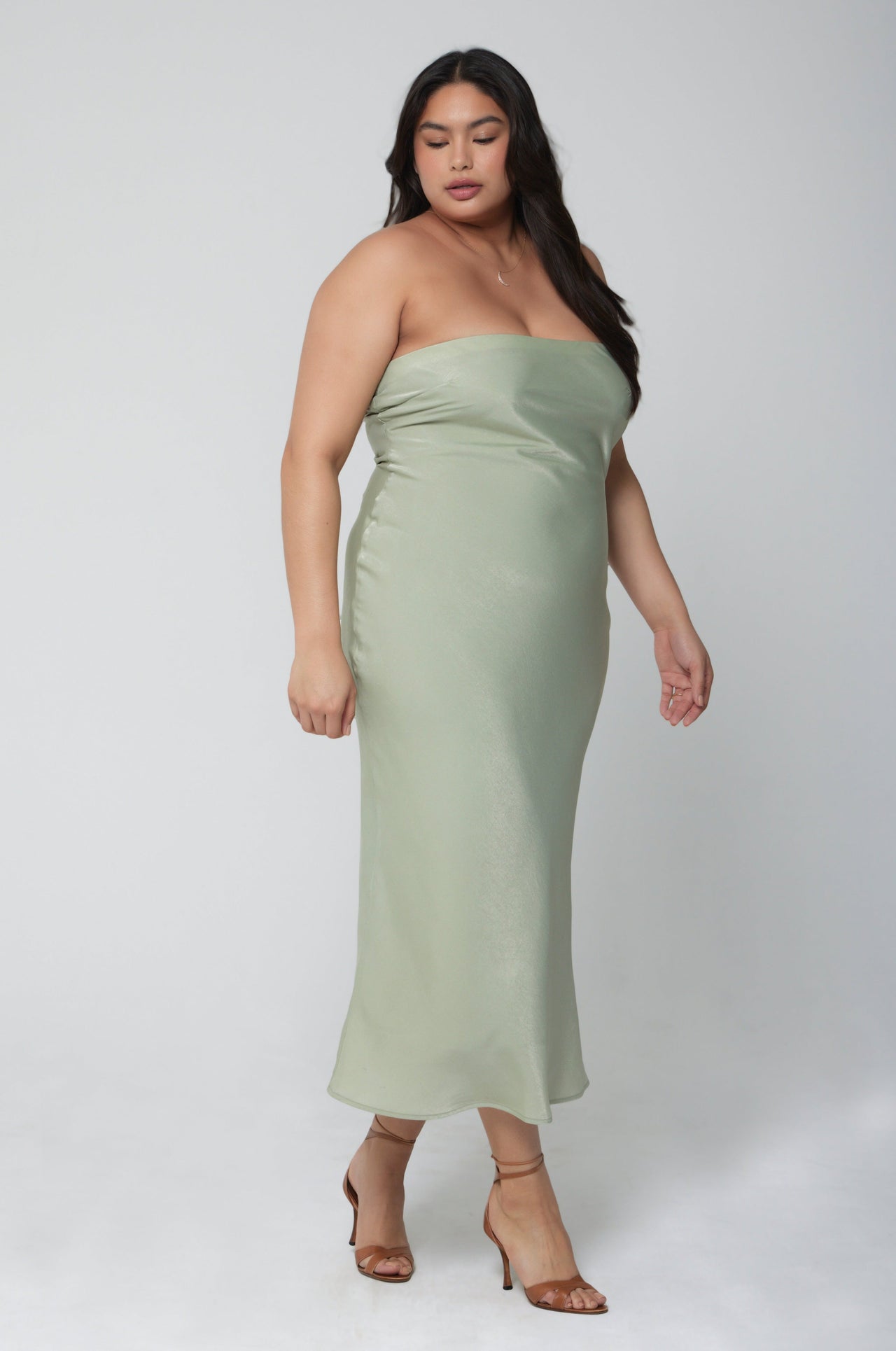 This is an image of Anna Slip in Sage - RESA featuring a model wearing the dress