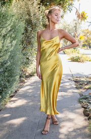 This is an image of Berri Slip in Gold - RESA featuring a model wearing the dress
