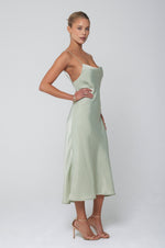This is an image of Berri Slip in Sage - RESA featuring a model wearing the dress