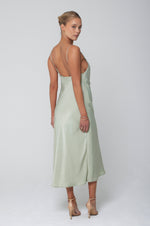 This is an image of Berri Slip in Sage - RESA featuring a model wearing the dress