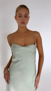 This is an image of Berri Slip in Sage - RESA featuring a model wearing the dress