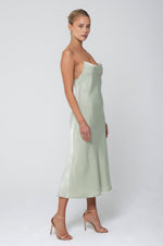 This is an image of Berri Slip in Sage - RESA featuring a model wearing the dress