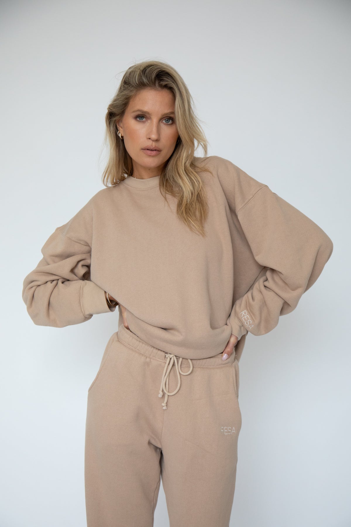This is an image of Bodhi Sweat pants in Sand - RESA featuring a model wearing the dress