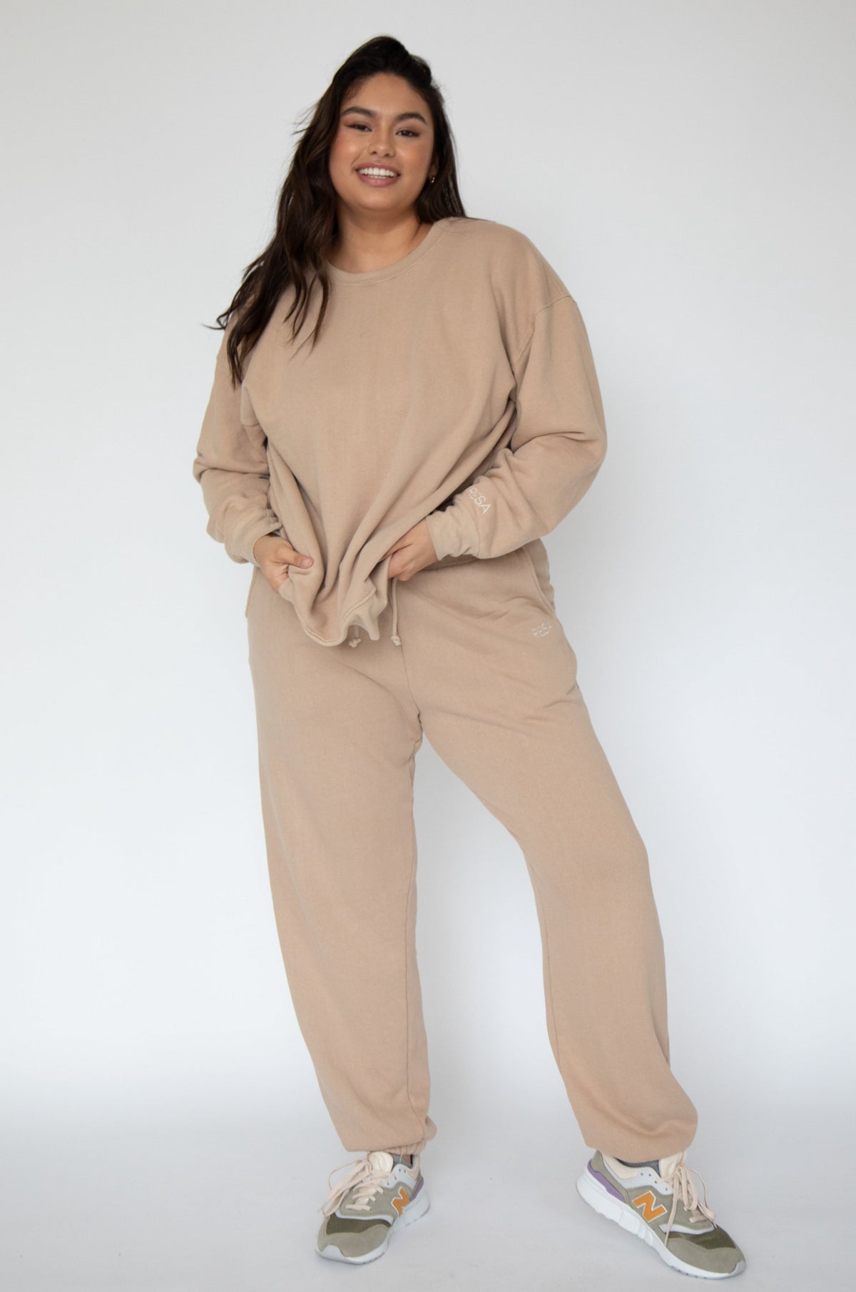 This is an image of Bodhi Sweat pants in Sand - RESA featuring a model wearing the dress