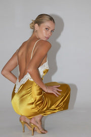 This is an image of Celine Dress in Gold - RESA featuring a model wearing the dress