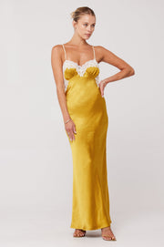 This is an image of Celine Dress in Gold - RESA featuring a model wearing the dress